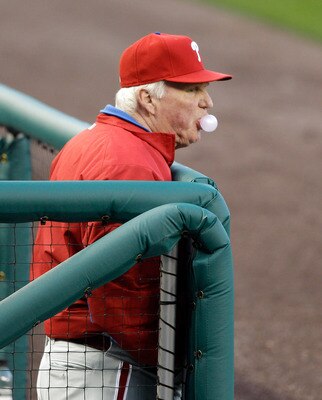 WASHINGTON, DC - APRIL 14: Manager Charlie Manuel #41 of the Philadelphia Phillies blows a bubble in the dugout during the scond inning of their game against the Washington Nationals at Nationals Park on April 14, 2011 in Washington, DC.  (Photo by Rob Ca