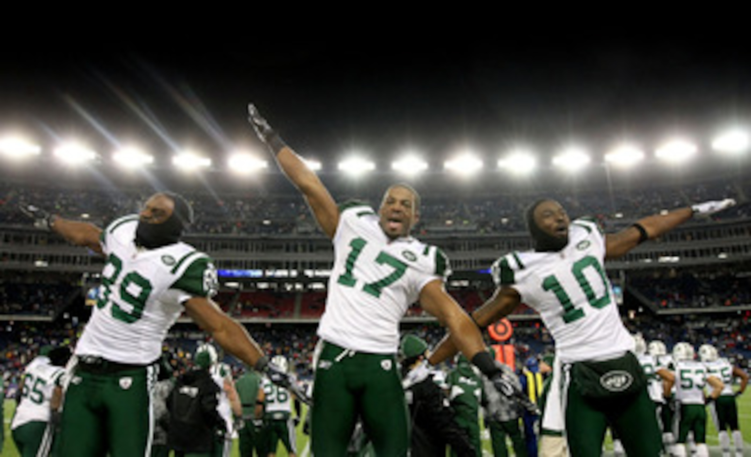 FOXBORO, MA - JANUARY 16:  Jerricho Cotchery #89, Braylon Edwards #17 and Santonio Holmes #10 of the New York Jets celebrate their 28 to 21 victory over the New England Patriots during their 2011 AFC divisional playoff game at Gillette Stadium on January 