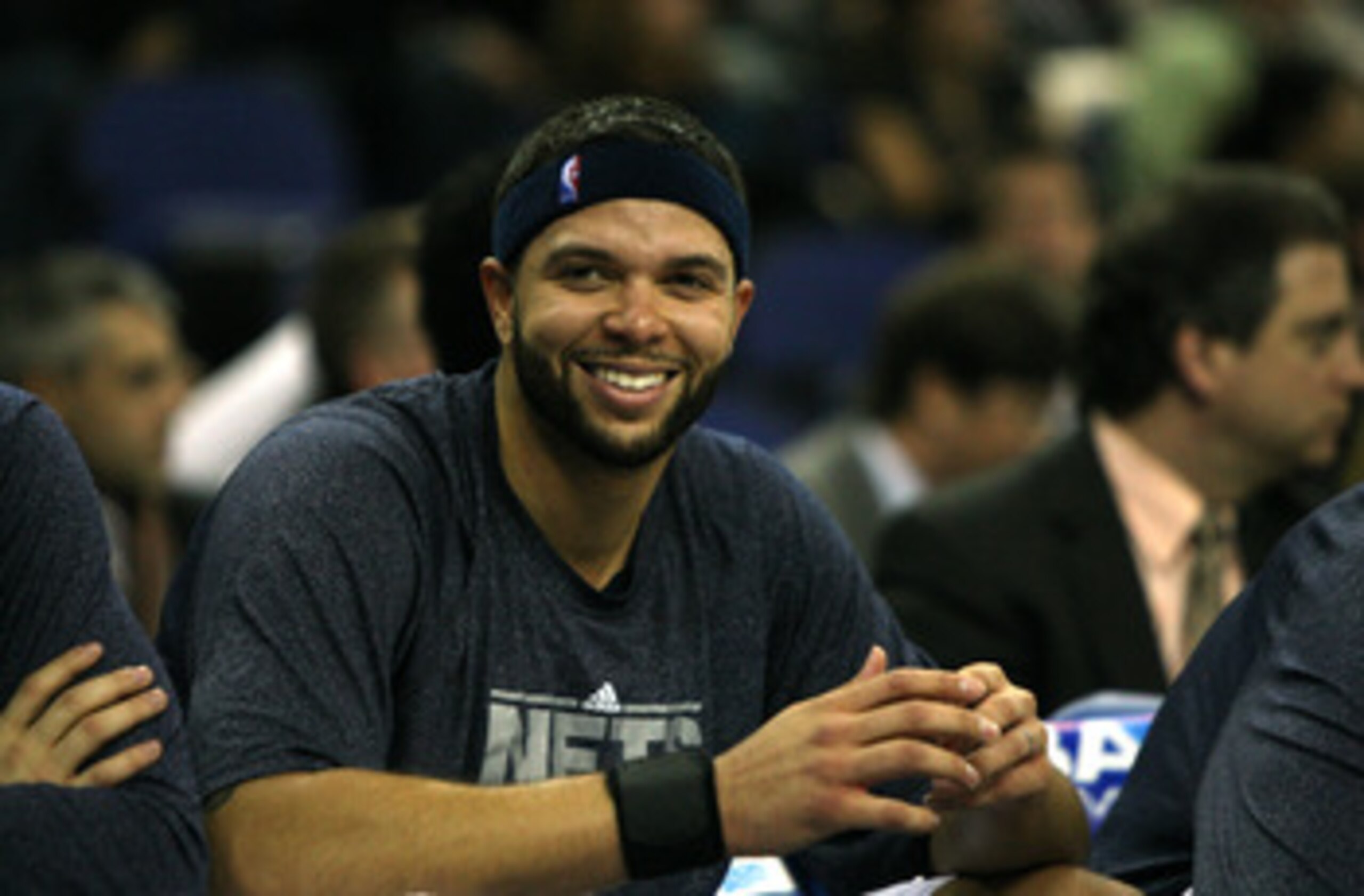LONDON, ENGLAND - MARCH 04:  #8 Deron Williams of the Netslooks on from the bench during the NBA match between New Jersey Nets and the Toronto Raptors at the O2 Arena on March 4, 2011 in London, England. NOTE TO USER: User expressly acknowledges and agree