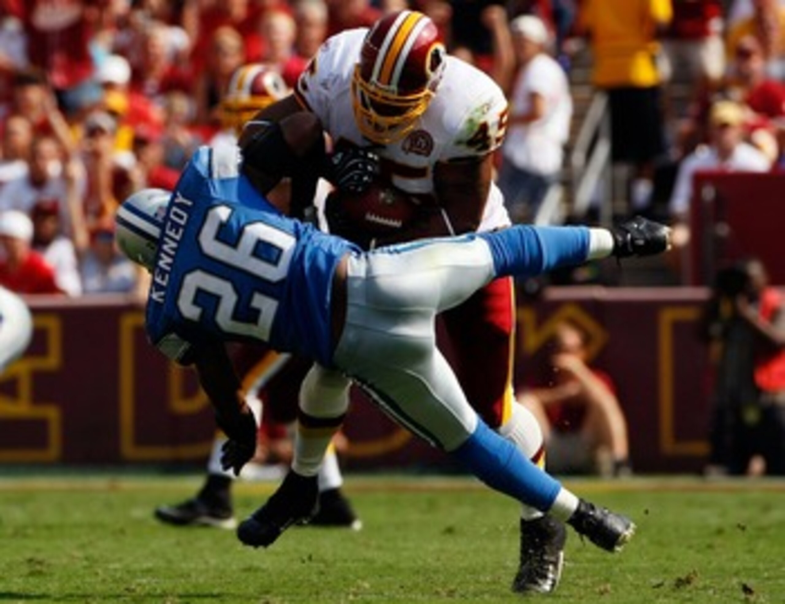 LANDOVER, MD - OCTOBER 07:  Running back Mike Sellers #45 of the Washington Redskins runs over Detroit Lions safety Kenoy Kennedy #26 in second quarter action at FedEx Field October 7, 2007 in Landover, Maryland. The Redskins defeated the Lions by a score