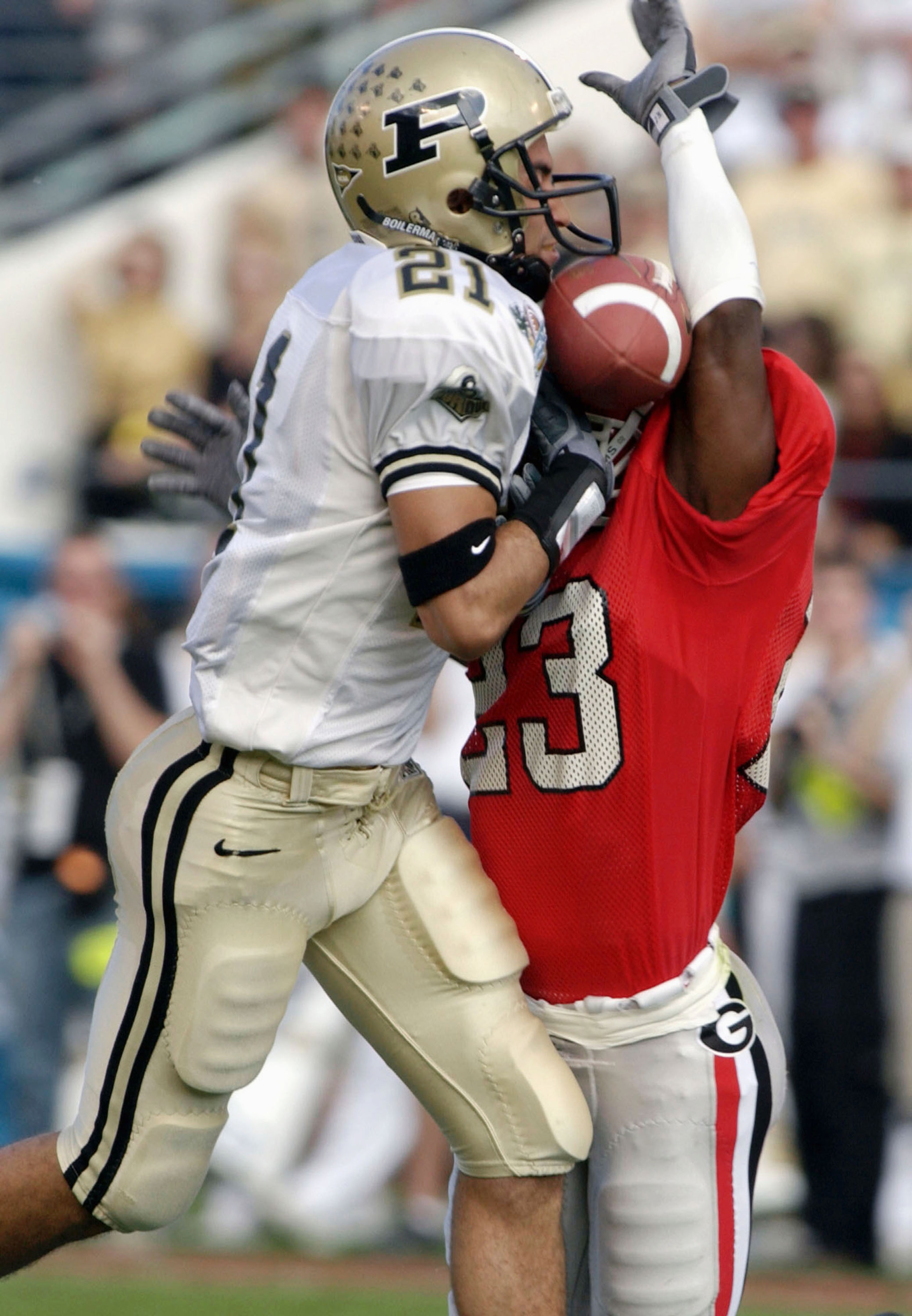ORLANDO, FL - JANUARY 1:  Tim Jennings #23 of the Georgia Bulldogs breaks up a pass to Taylor Stubblefield #21 of the Purdue Boilermakers on January 1, 2004 during the Capital One Bowl at Florida Citrus Bowl Stadium in Orlando, Florida. The Bulldogs won 3