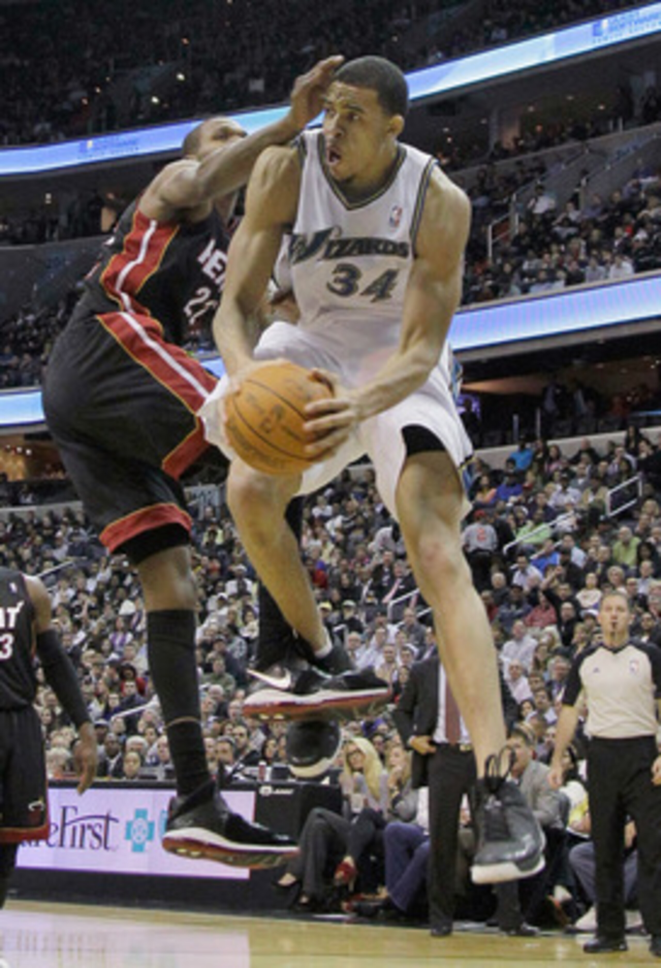 WASHINGTON, DC - MARCH 30: JaVale McGee #34 of the Washington Wizards puts up a shot while being guarded by James Jones #22 of the Miami Heat during the second half at the Verizon Center on March 30, 2011 in Washington, DC. NOTE TO USER: User expressly ac