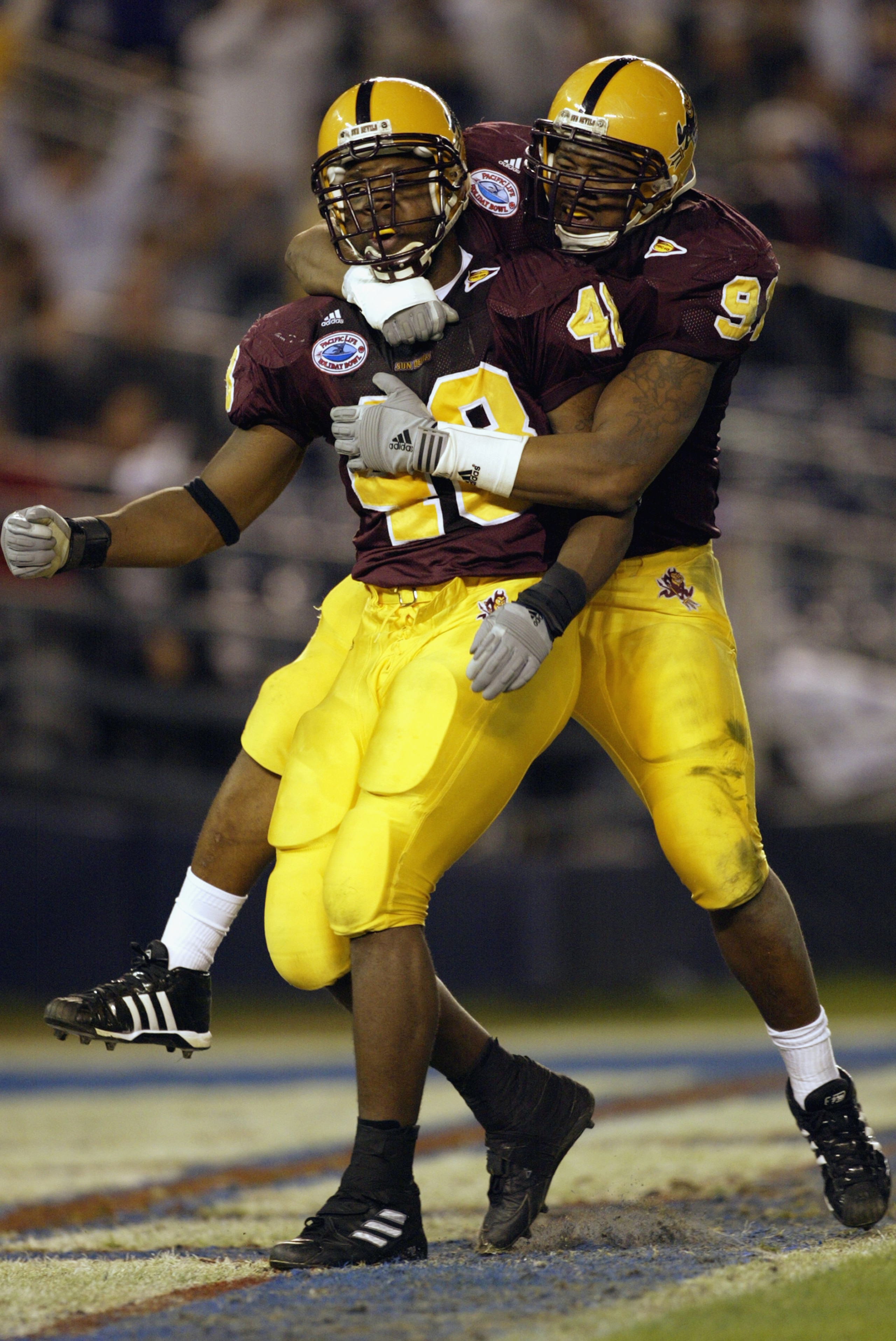 SAN DIEGO - DECEMBER 27:  Terrell Suggs #48 and Jimmy Verdon #91 of the Arizona State Sun Devils celebrate during the Pacific Life Holiday Bowl against the Kansas State Wildcats at Qualcomm Stadium on December 27, 2002 in San Diego, California.  The Wildc