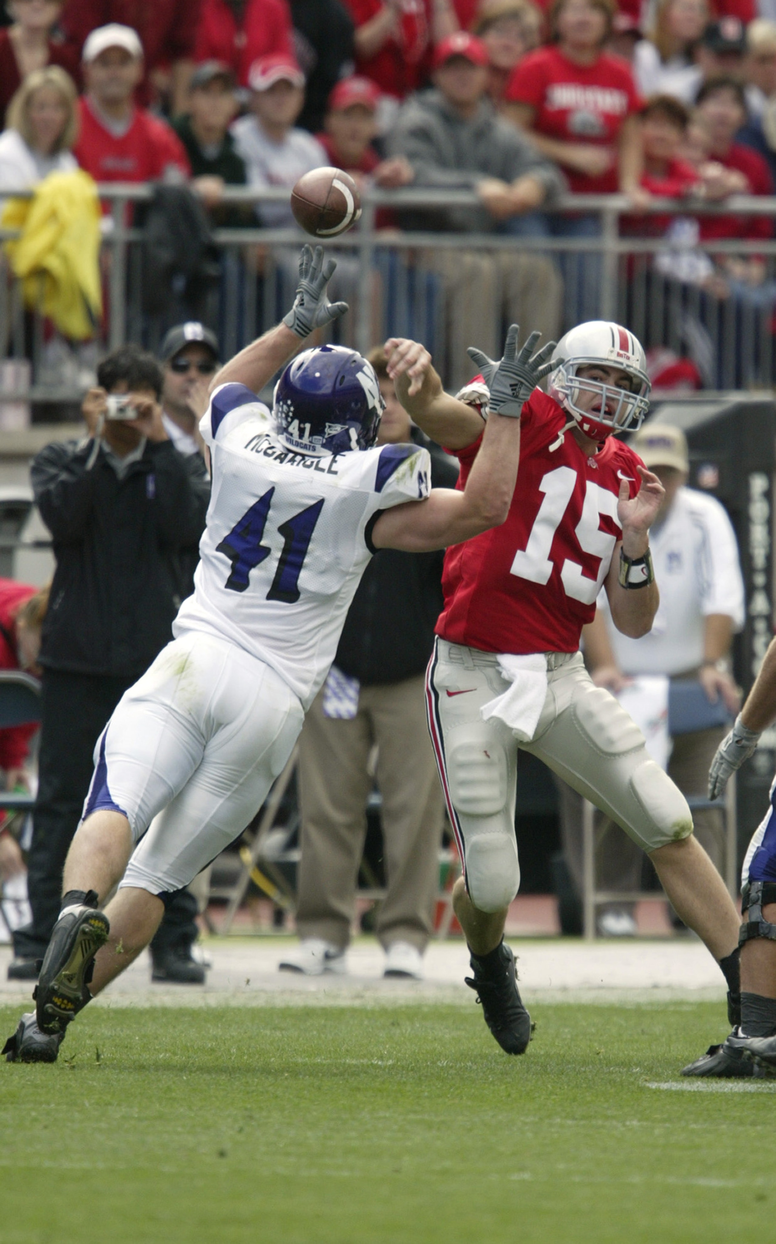 COLUMBUS, OH - SEPTEMBER 27:  Scott McMullen #15 of the Ohio State Buckeyes throws under pressure from Tim McGarigle #41 of the Northwestern Wild Cats on September 27, 2003 at Ohio Stadium in Columbus, Ohio. Ohio State defeated Northwestern 23-0. (Photo b