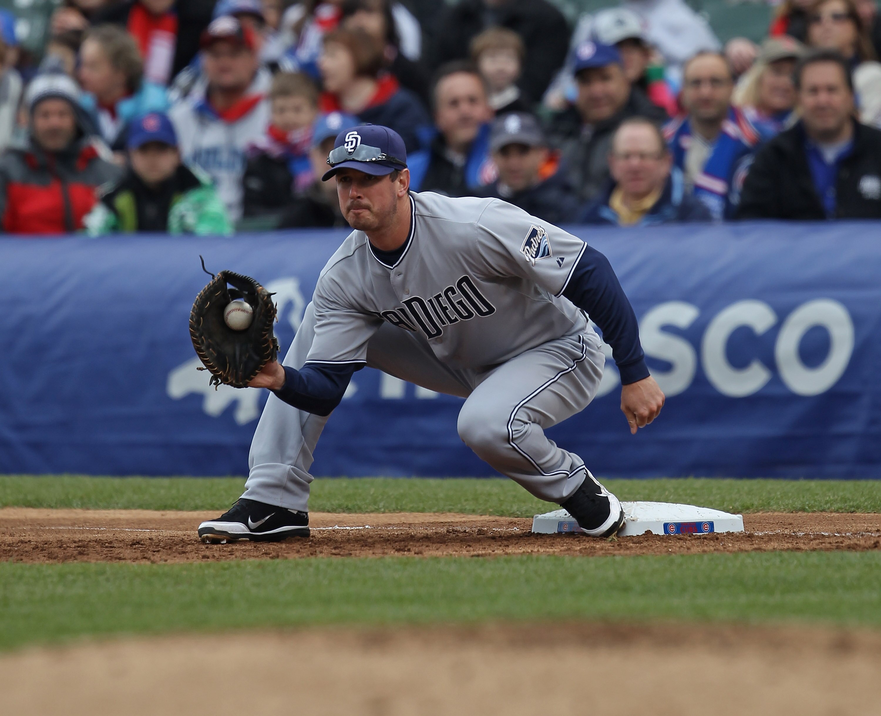 CHICAGO, IL - APRIL 20: Brad Hawpe #11 of the San Diego Padres catches the ball at first base for an out against the Chicago Cubs at Wrigley Field on April 20, 2011 in Chicago, Illinois. The Cubs defeated the Padres 2-1 in 11 innings. (Photo by Jonathan D