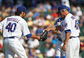 CHICAGO - JULY 21: Manager Lou Piniella #41 of the Chicago Cubs gives the ball to James Russell #40 during a game against the Houston Astros at Wrigley Field on July 21, 2010 in Chicago, Illinois. The Astros defeated the Cubs 4-3 in 12 innings. (Photo by