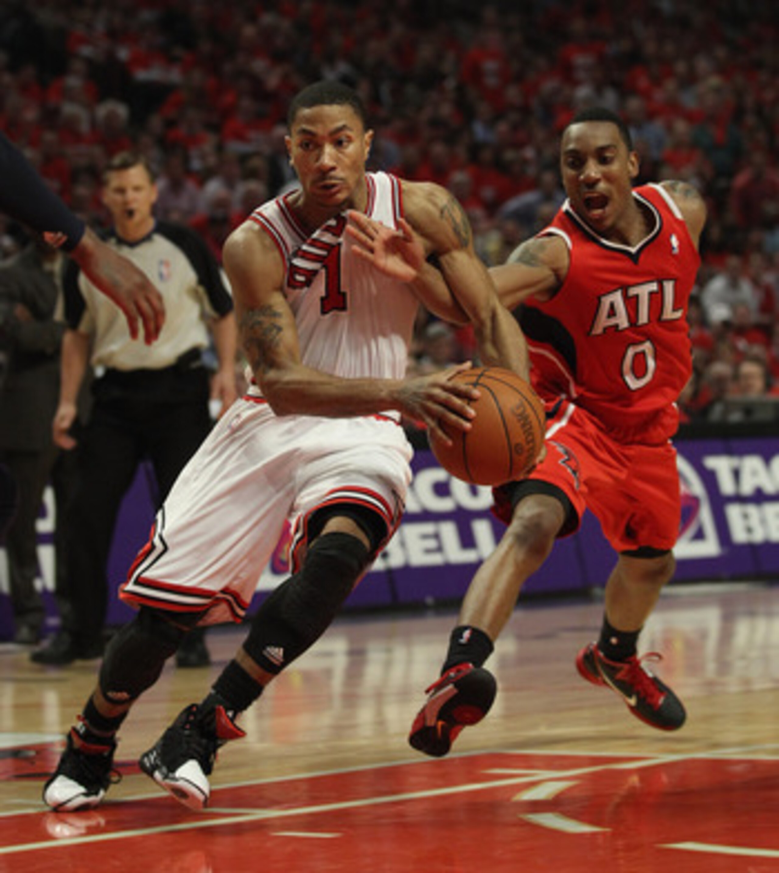 CHICAGO, IL - MAY 10: Derrick Rose #1 of the Chicago Bulls drives to the basket under pressure from Jeff Teague #0 of the Atlanta Hawks in Game Five of the Eastern Conference Semifinals in the 2011 NBA Playoffs at the United Center on May 10, 2011 in Chic