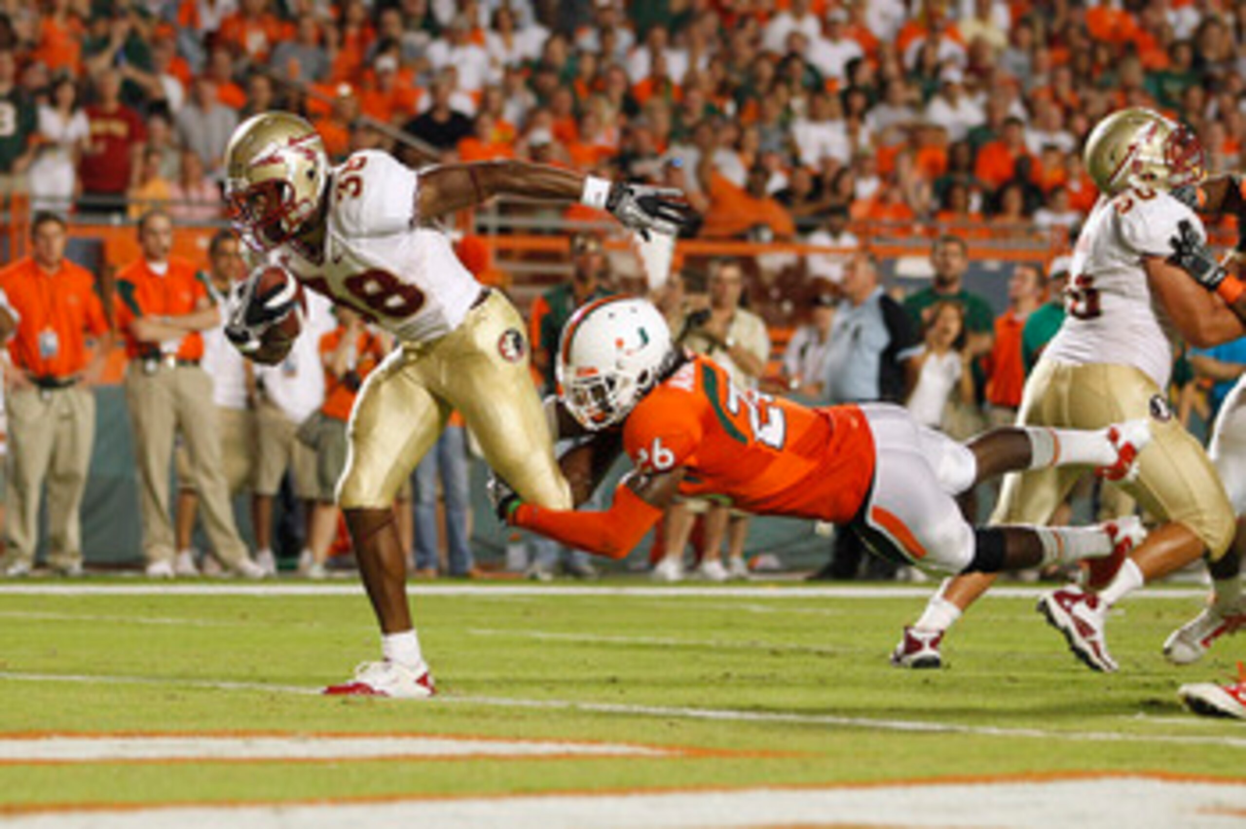MIAMI, FL - OCTOBER 9: Jermaine Thomas #38 of the Florida State Seminoles breaks the tackle of Ray-Ray Armstrong #26 of the Miami Hurricanes to score a touchdown in the second quarter on October 9, 2010 at Sun Life Stadium in Miami, Florida. (Photo by Joe MIAMI, FL - OCTOBER 9: Jermaine Thomas #38 of the Florida State Seminoles breaks the tackle of Ray-Ray Armstrong #26 of the Miami Hurricanes to score a touchdown in the second quarter on October 9, 2010 at Sun Life Stadium in Miami, Florida. (Photo by Joe