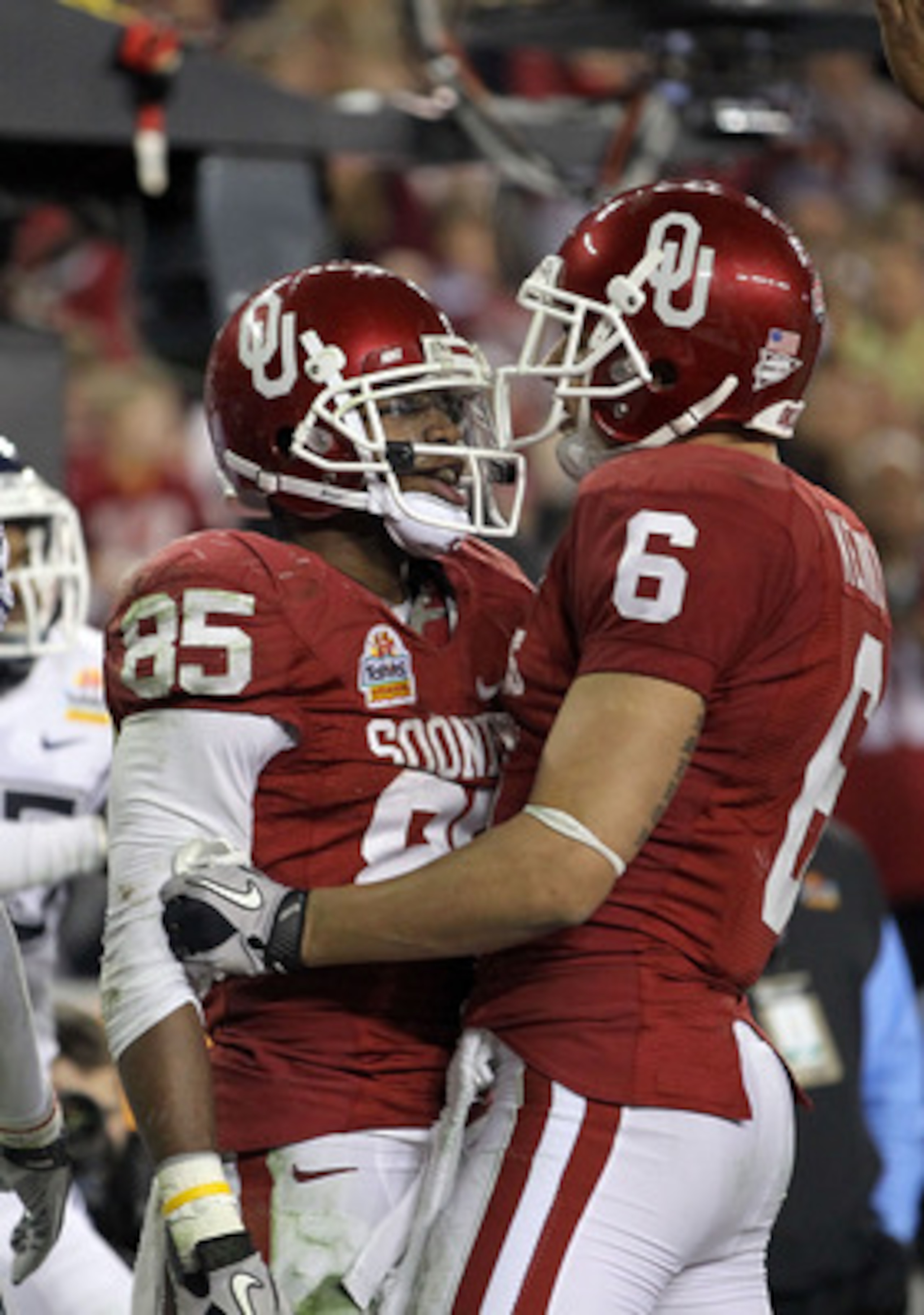 GLENDALE, AZ - JANUARY 01:  Ryan Broyles #85 of the Oklahoma Sooners celebreates with teammate Cameron Kenney #6 after Broyles scores a five-yard touchdown catch in the fourth quarter against Connecticut Huskies during the Tostitos Fiesta Bowl at the Univ