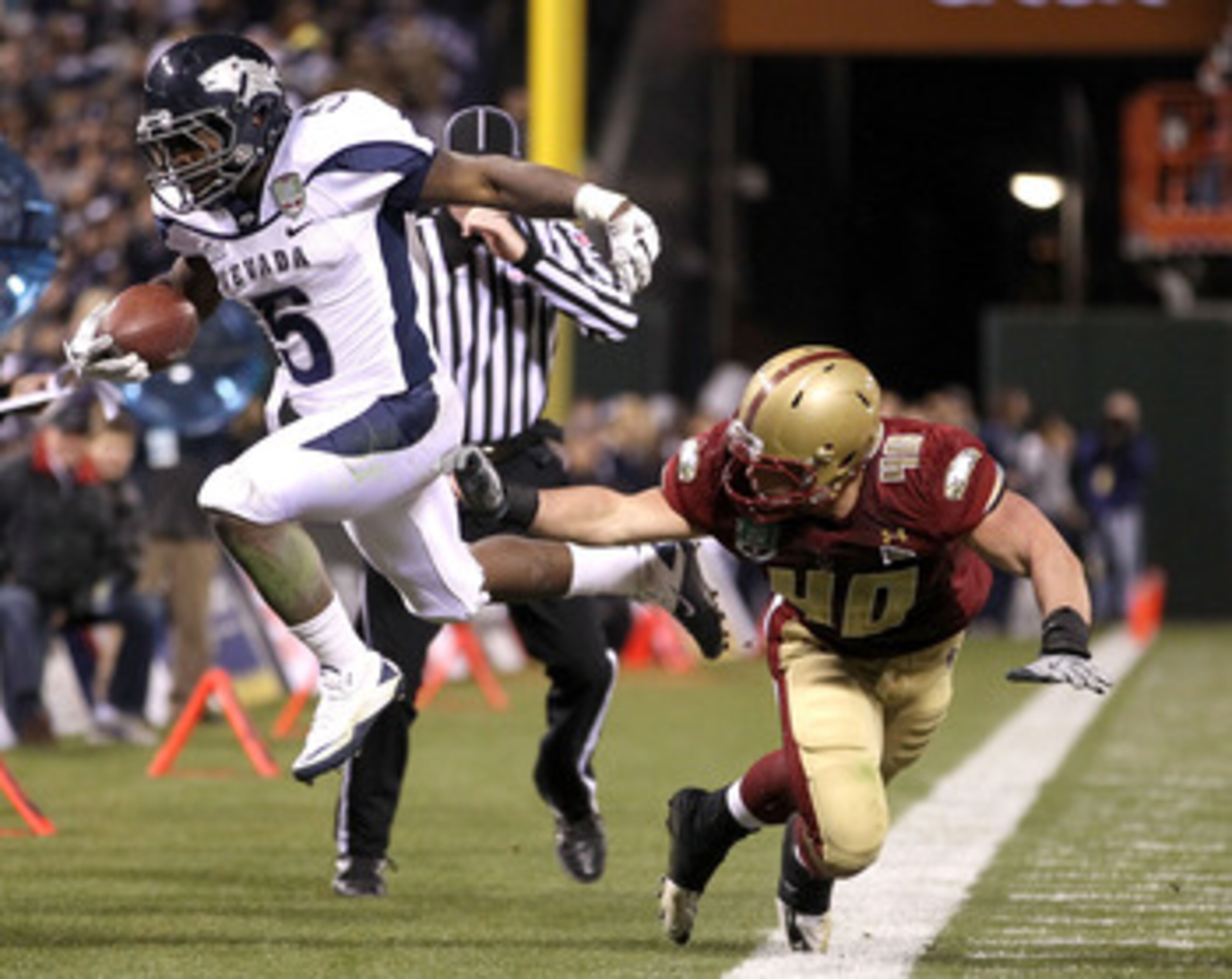 SAN FRANCISCO, CA - JANUARY 09:  Mike Ball #5 of the Nevada Wolf Pack is pushed out of bounds by Luke Kuechly #40 of Boston College during the Kraft Fight Hunger Bowl at AT&T Park on January 9, 2011 in San Francisco, California.  (Photo by Ezra Shaw/Getty
