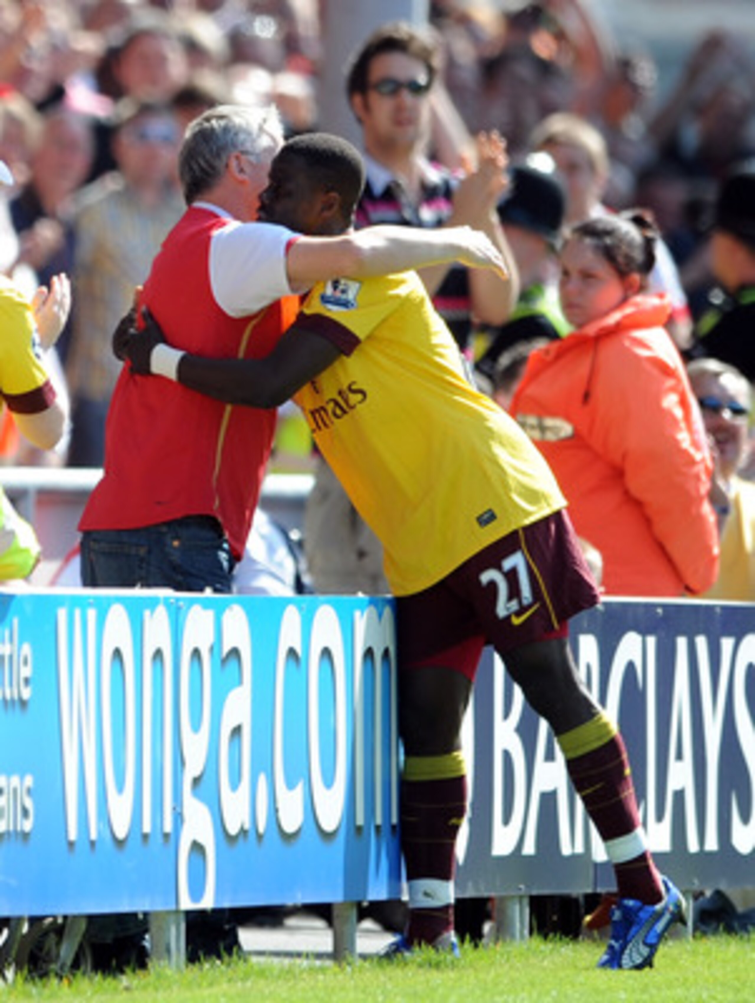 BLACKPOOL, ENGLAND - APRIL 10: Emmanuel Eboue of Arsenal celebrates scoring his side's second goal with a supporter during the Barclays Premier League match between Blackpool and Arsenal at Bloomfield Road on April 10, 2011 in Blackpool, England.  (Photo 