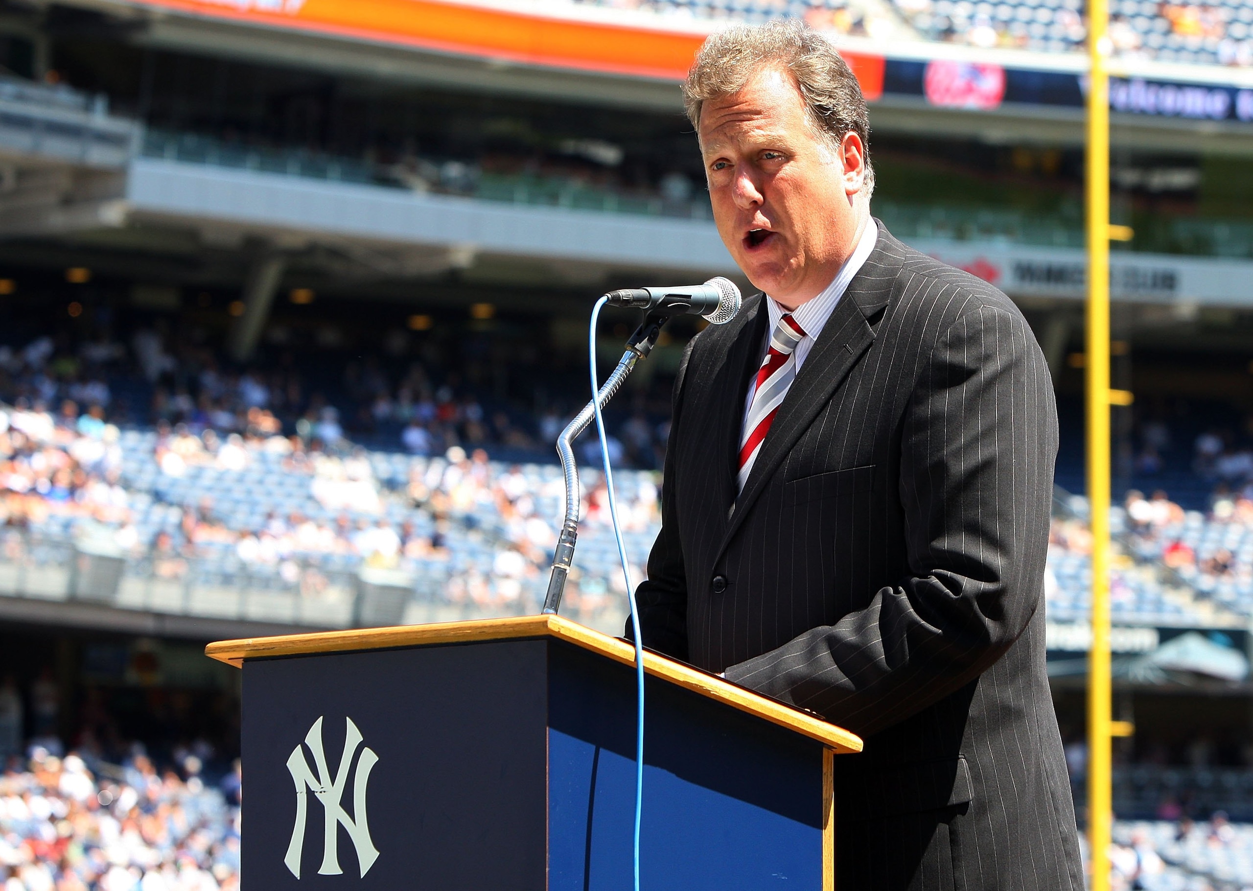 NEW YORK - JULY 19:  New York Yankees television broadcaster Michael Kay speaks during the teams 63rd Old Timers Day before the game against the Detroit Tigers on July 19, 2009 at Yankee Stadium in the Bronx borough of New York City.  (Photo by Jim McIsaa