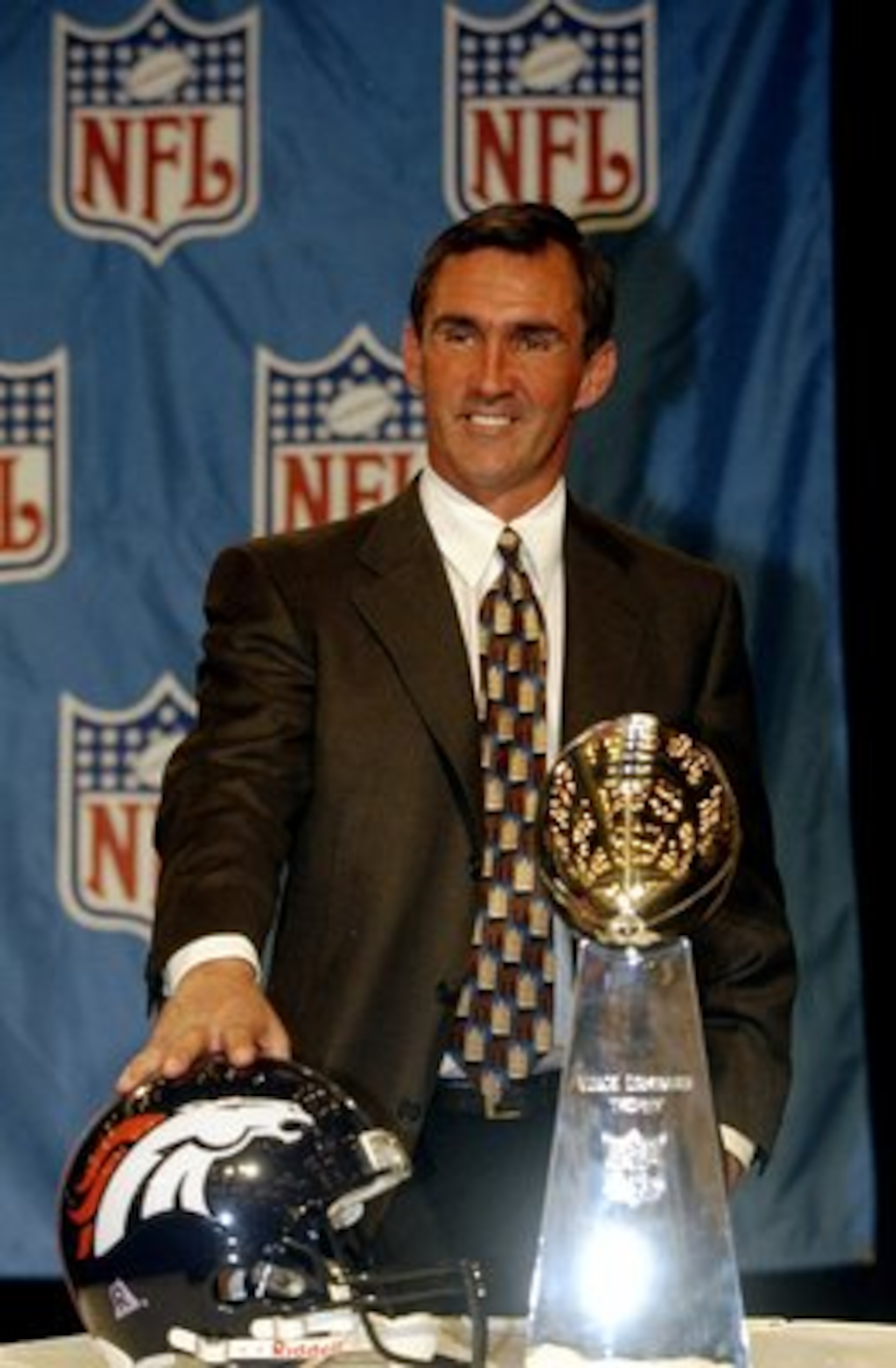 1 Feb 1999:  Head Coach Mike Shanahan of the Denver Broncos stands behind the Vince Lombardi Trophy smilling at the press during the MVP Press Conference after the Super Bowl XXXIII Game Between the Denver Broncos and the Atlanta Falcons at the Pro Player