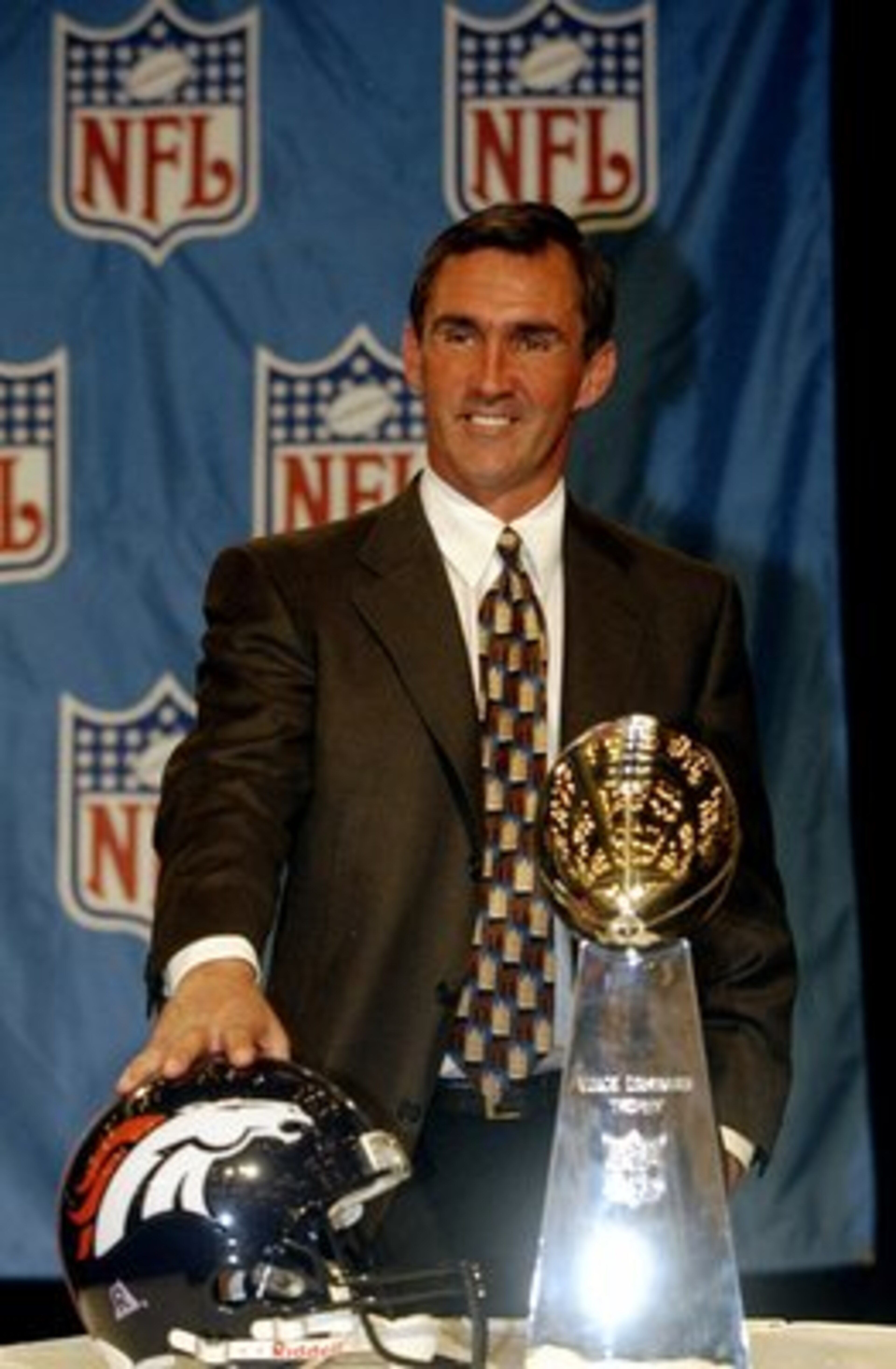 1 Feb 1999:  Head Coach Mike Shanahan of the Denver Broncos stands behind the Vince Lombardi Trophy smilling at the press during the MVP Press Conference after the Super Bowl XXXIII Game Between the Denver Broncos and the Atlanta Falcons at the Pro Player