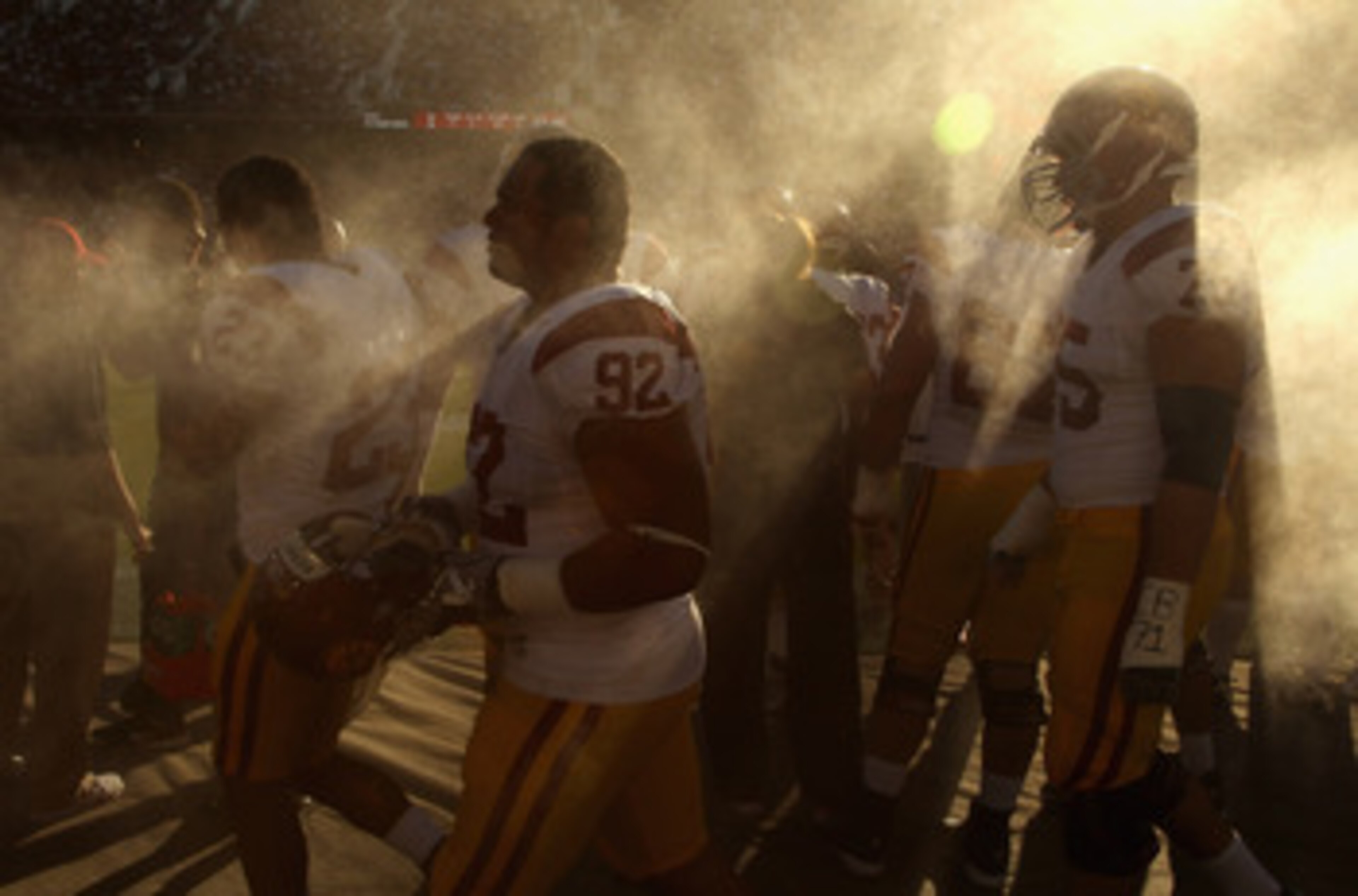 PALO ALTO, CA - OCTOBER 09:  Hebron Fangupo #92 and Matt Kalil #75 of the USC Trojans walk by a spray fan during their game against the Stanford Cardinal at Stanford Stadium on October 9, 2010 in Palo Alto, California.  (Photo by Ezra Shaw/Getty Images)