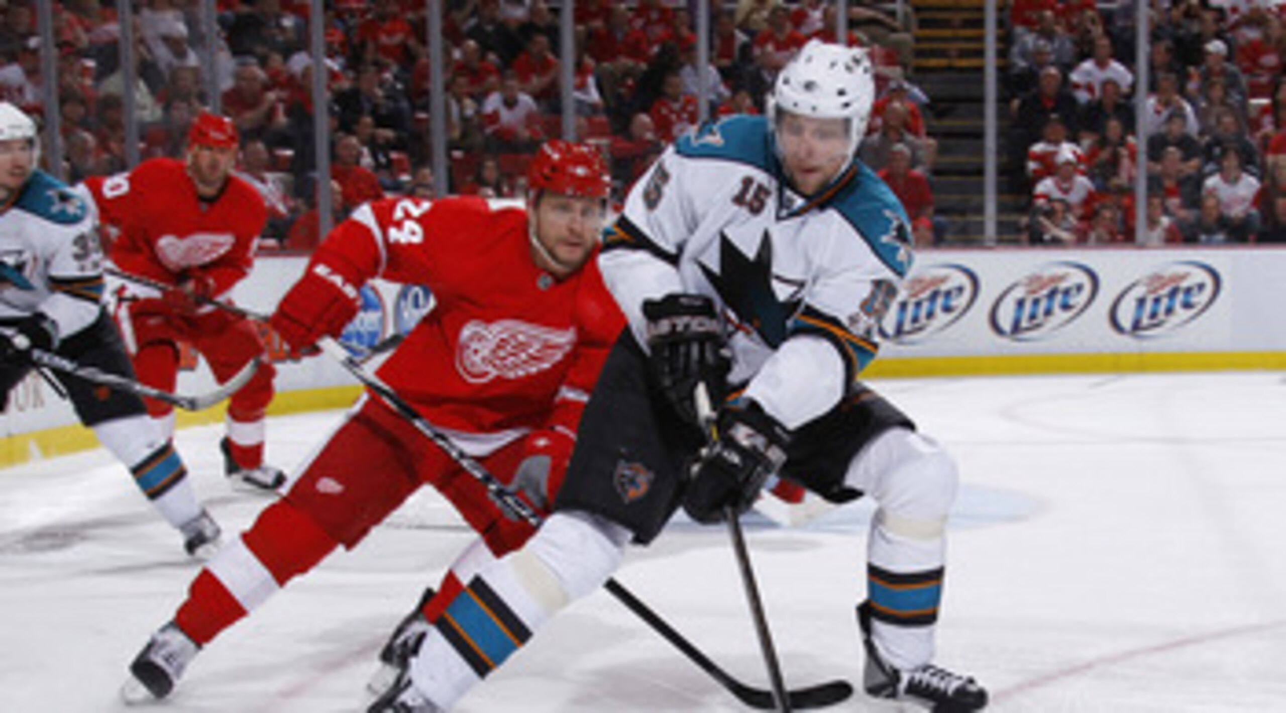 DETROIT - MAY 10: Dany Heatley #15 of the San Jose Sharks controls the puck during the third period in front of Ruslan Salei #24 of the Detroit Red Wings in Game Six of the Western Conference Semifinals during the 2011 NHL Stanley Cup Playoffs on May 10,