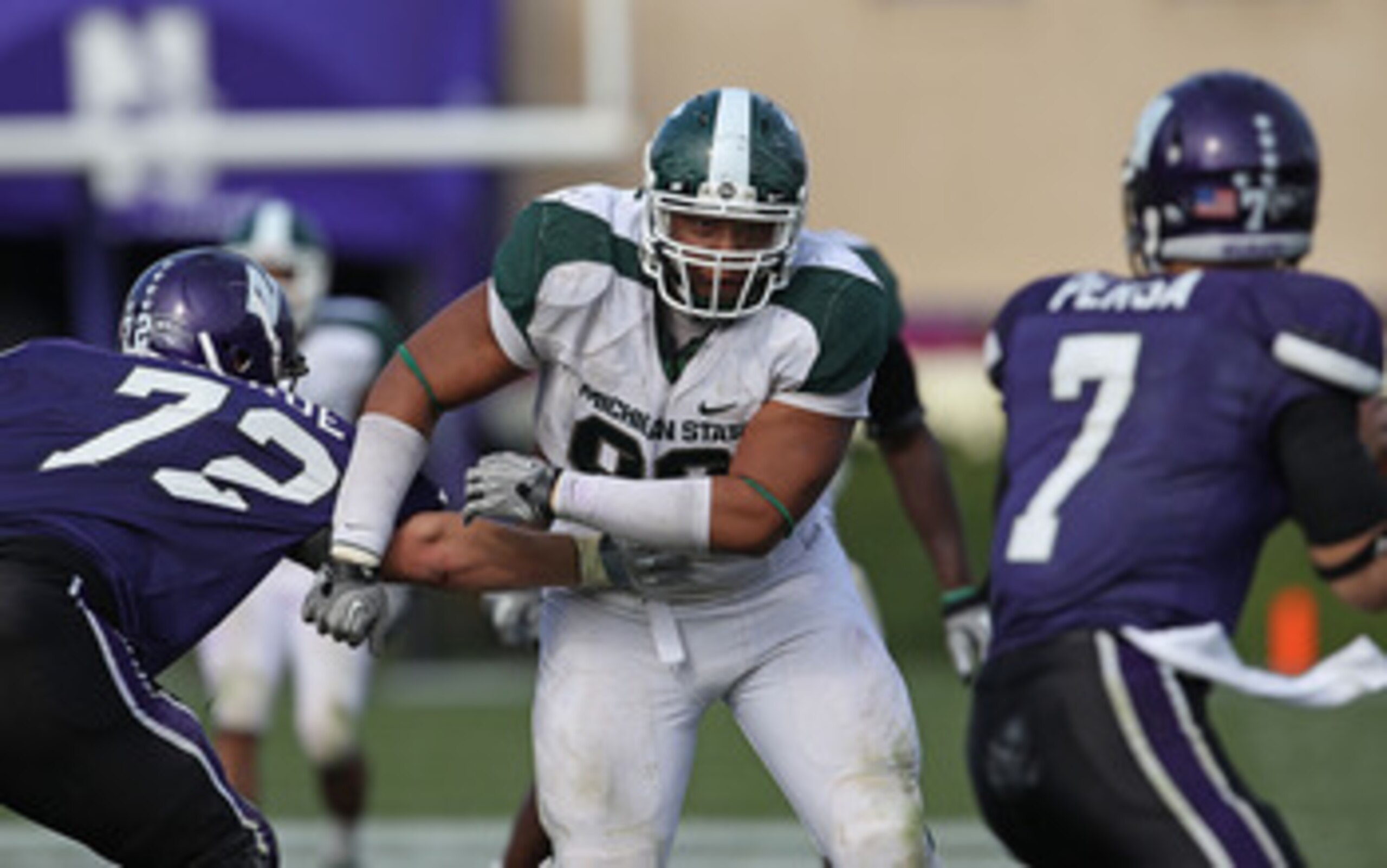 EVANSTON, IL - OCTOBER 23: Jerel Worthy #99 of the Michigan State Spartans moves past a block attempt by Brian Mulroe #72 of the Northwestern Wildcats with his sights set on Dan Persa #7 at Ryan Field on October 23, 2010 in Evanston, Illinois. Michigan St EVANSTON, IL - OCTOBER 23: Jerel Worthy #99 of the Michigan State Spartans moves past a block attempt by Brian Mulroe #72 of the Northwestern Wildcats with his sights set on Dan Persa #7 at Ryan Field on October 23, 2010 in Evanston, Illinois. Michigan St