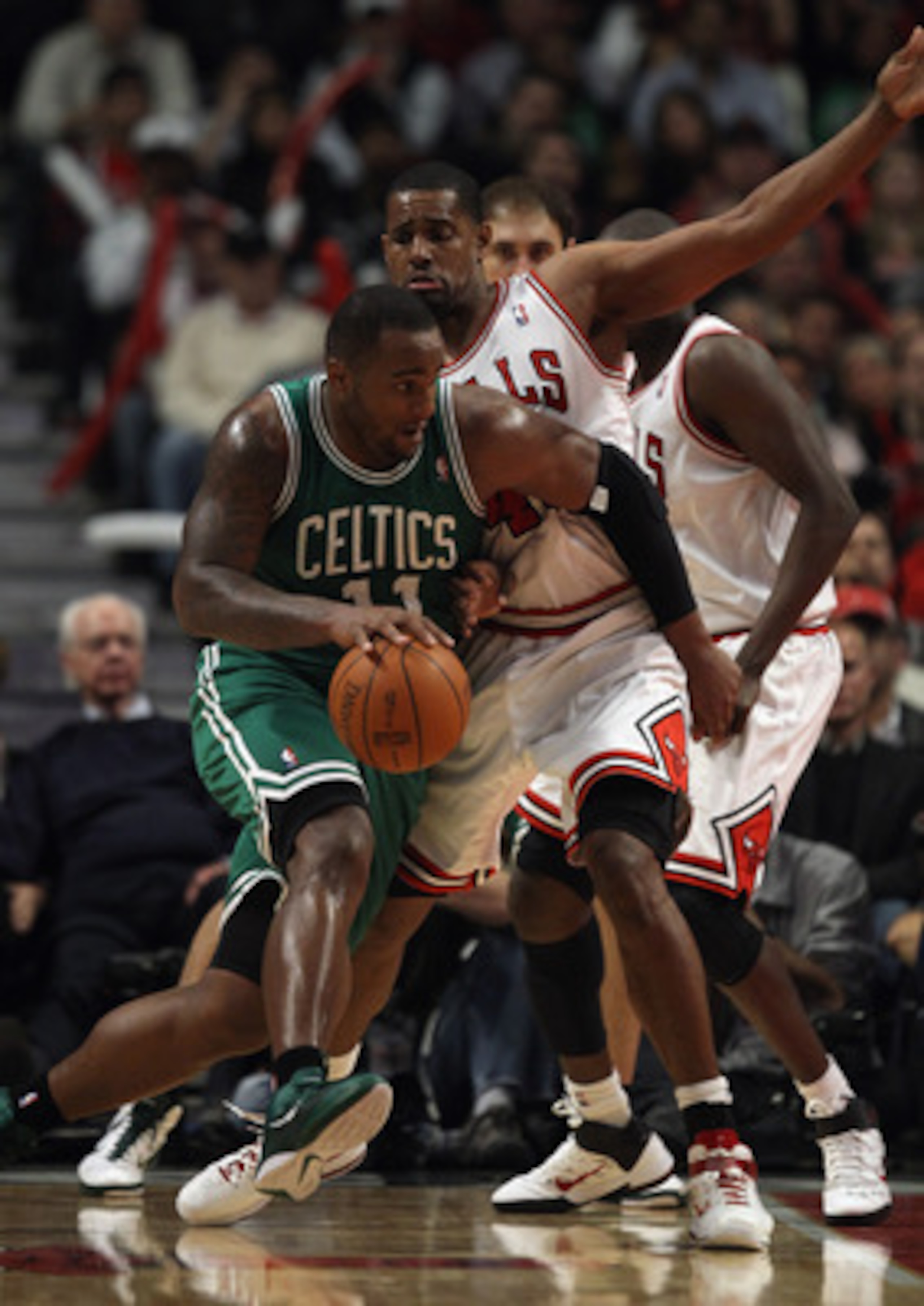 CHICAGO, IL - APRIL 07: Glen Davis #11 of the Boston Celtics moves against Kurt Thomas #40 of the Chicago Bulls at United Center on April 7, 2011 in Chicago, Illinois. The Bulls defeated the Celtics 97-81. NOTE TO USER: User expressly acknowledges and agr