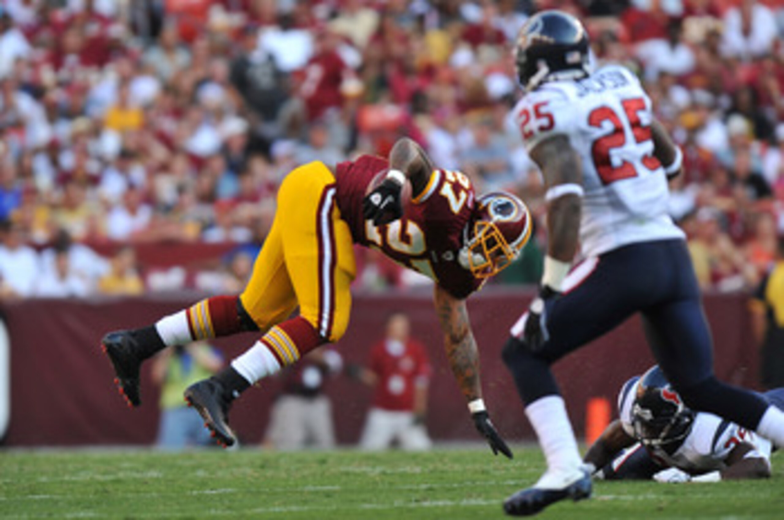 LANDOVER - SEPTEMBER 19:  Larry Johnson #27 of the Washington Redskins runs the ball against the Houston Texans at FedExField on September 19, 2010 in Landover, Maryland. The Texans defeated the Redskins in overtime 30-27. (Photo by Larry French/Getty Ima
