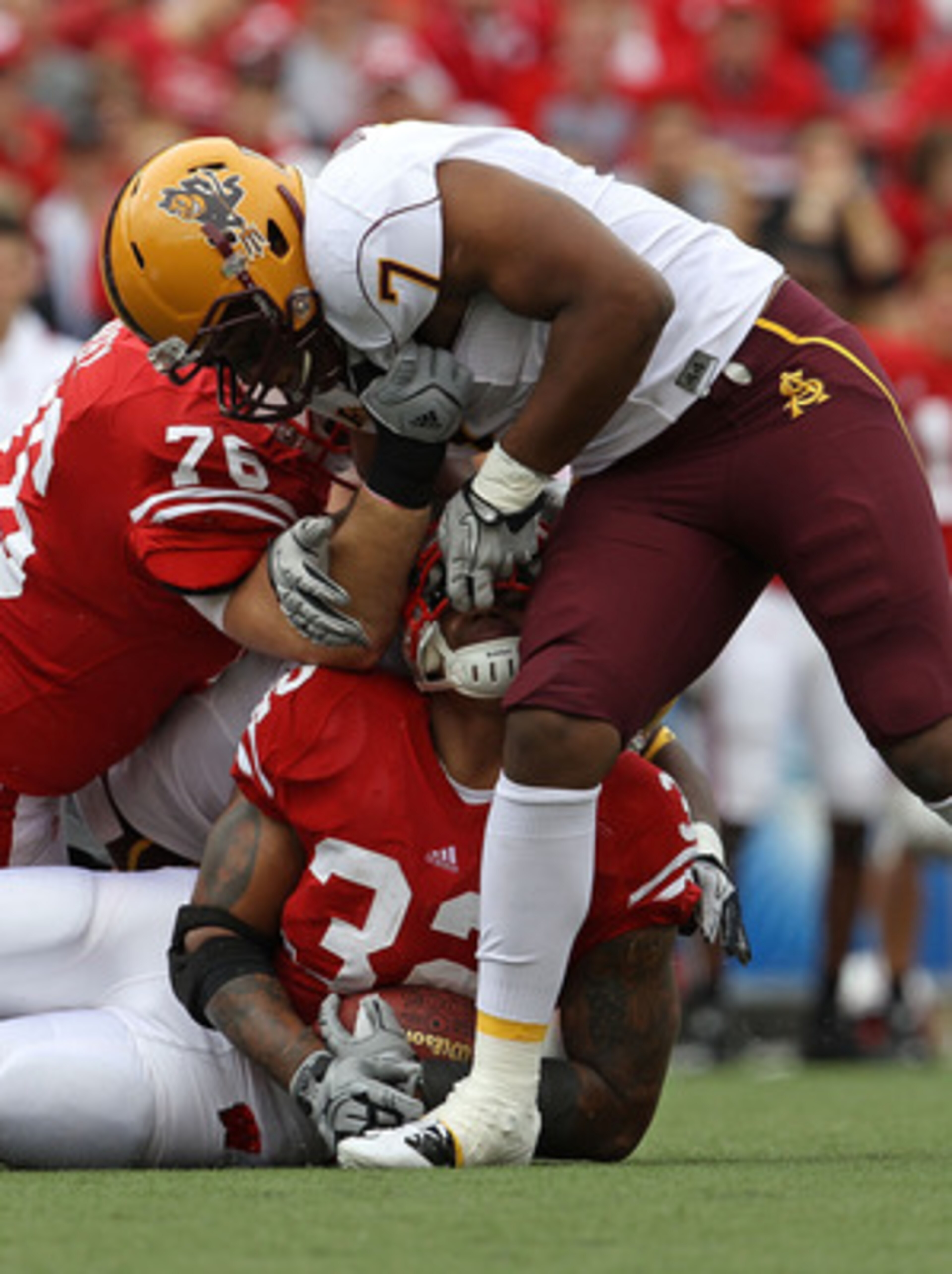 MADISON, WI - SEPTEMBER 18: John Clay #32 of the Wisconsin Badgers is tackled by the fask mask by Vontaze Burfict #7 of the Arizona State Sun Devils at Camp Randall Stadium on September 18, 2010 in Madison, Wisconsin. (Photo by Jonathan Daniel/Getty Image