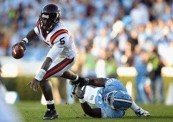 CHAPEL HILL, NC - NOVEMBER 13:  Tyrod Taylor #5 of the Virginia Tech Hokies tries to get away from Quinton Coples #90 of the North Carolina Tar Heels during their game at Kenan Stadium on November 13, 2010 in Chapel Hill, North Carolina.  (Photo by Street
