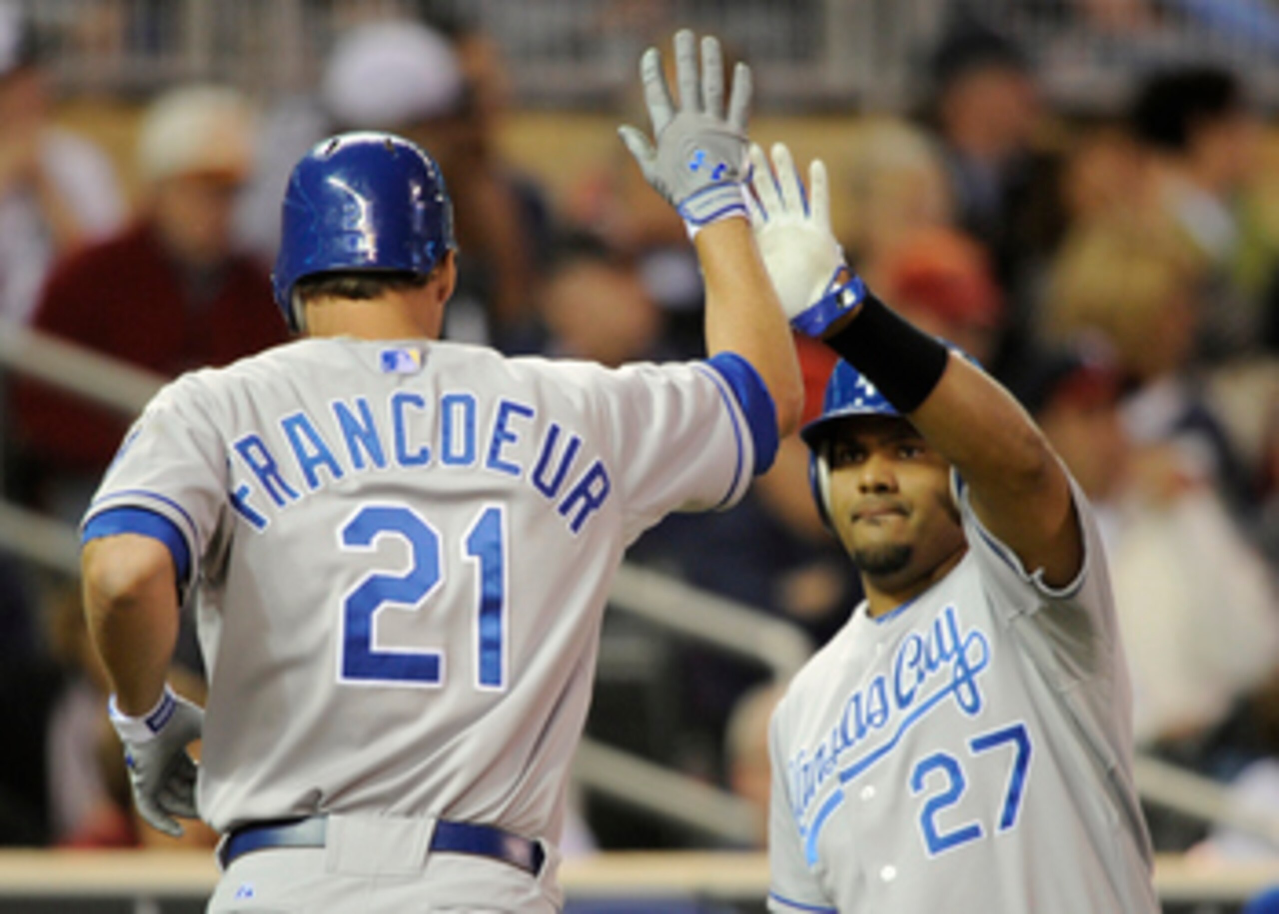 MINNEAPOLIS, MN - APRIL 12: Jeff Francoeur #21 and Brayan Pena #27 of the Kansas City Royals celebrate Francoeur scoring against the Minnesota Twins during the fourth inning of their game on April 12, 2011 at Target Field in Minneapolis, Minnesota. (Photo
