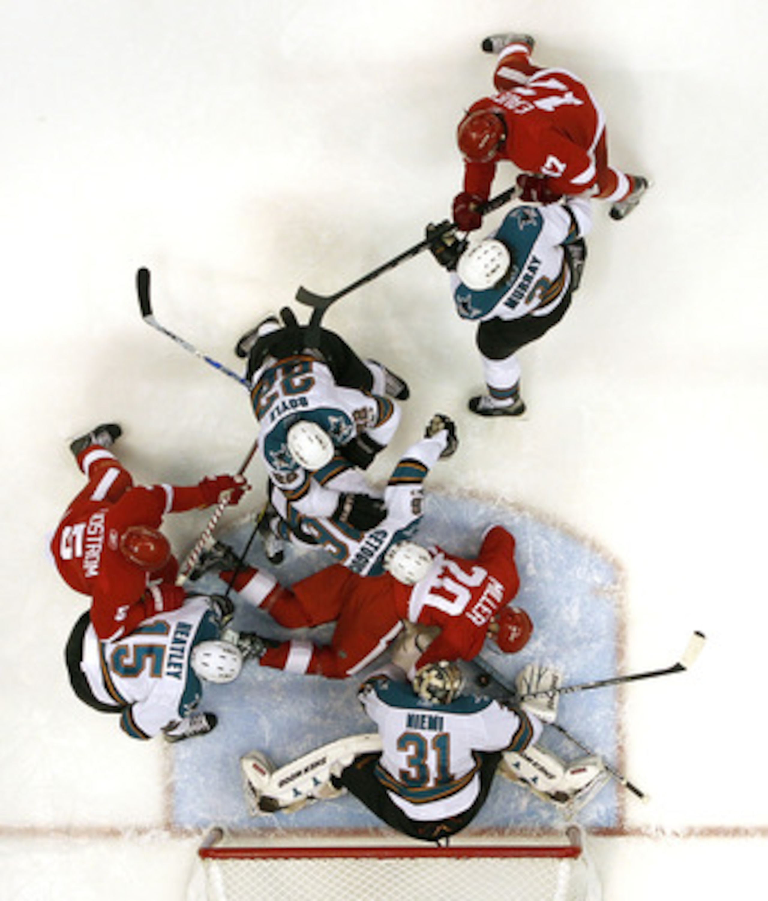 DETROIT - MAY 10: Antti Niemi #31 of the San Jose Sharks makes a save in front of Drew Miller #20 of the Detroit Red Wings in Game Six of the Western Conference Semifinals during the 2011 NHL Stanley Cup Playoffs on May 10, 2011 at Joe Louis Arena in Detr