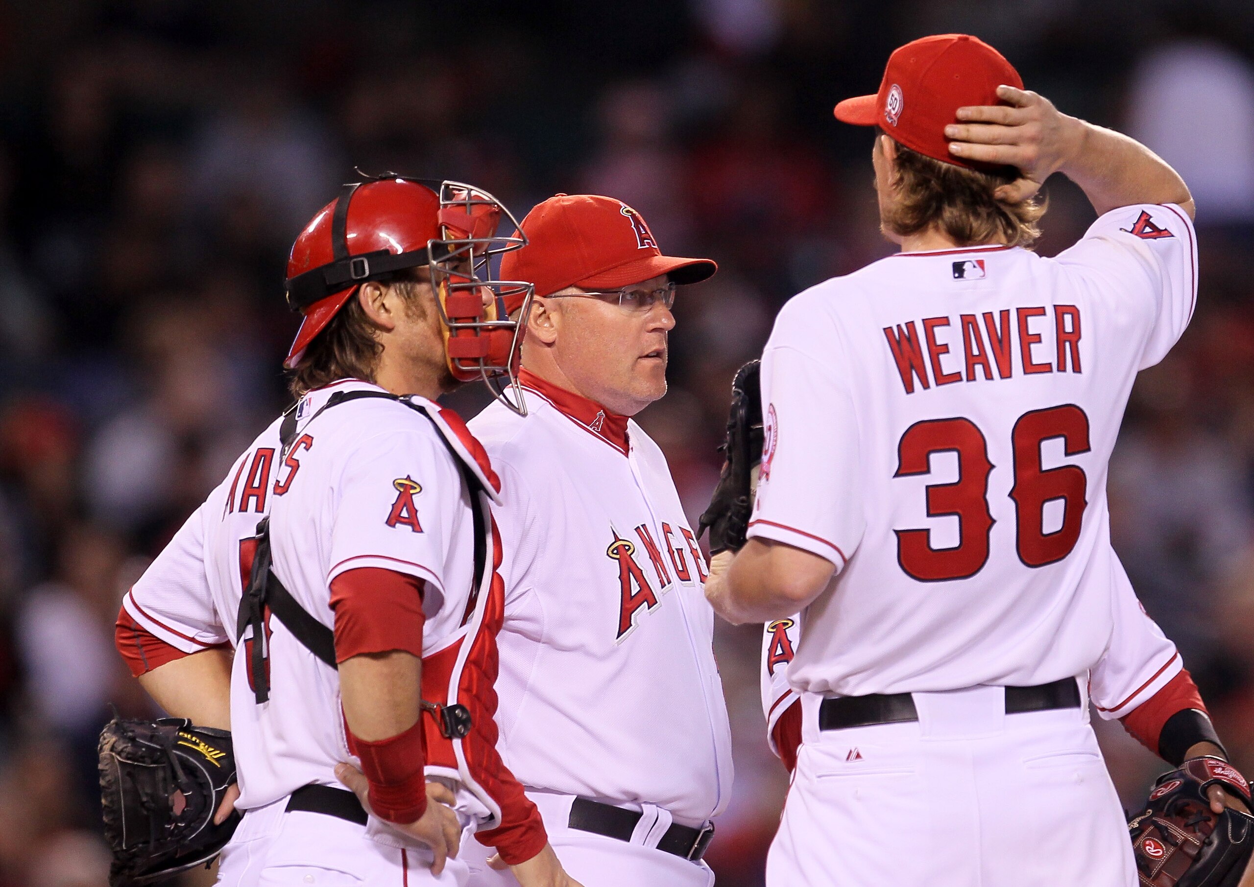 ANAHEIM, CA - MAY 7:  Pitching coach Mike Butcher (C) of the Los Angeles Angels of Anaheim meets with pitcher Jered Weaver #36 and catcher Jeff Mathis $5 during the fifth inning against the Cleveland Indians on May 7, 2011 at Angel Stadium in Anaheim, Cal