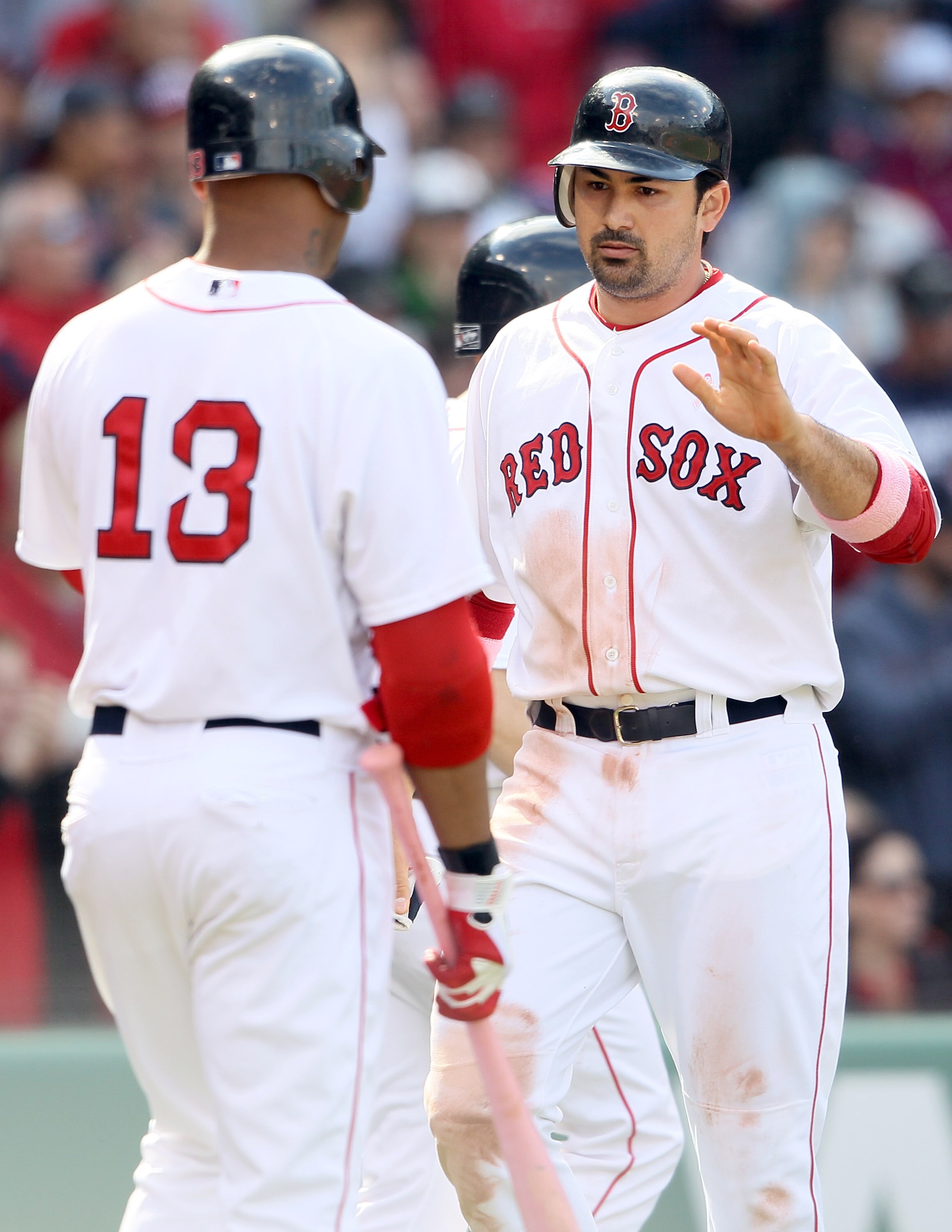 BOSTON, MA - MAY 08:  Adrian Gonzalez #28 of the Boston Red Sox is congratulated by teammate Carl Crawford #13 after Gonzalez scored in the seventh inning against the Minnesota Twins on May 8, 2011 at Fenway Park in Boston, Massachusetts.  (Photo by Elsa/