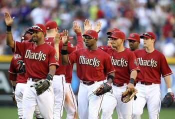 PHOENIX, AZ - MAY 01:  Justin Upton #10 of the Arizona Diamondbacks high fives teammates after defeating the Chicago Cubs in the Major League Baseball game at Chase Field on May 1, 2011 in Phoenix, Arizona.  The Diamondbacks defeated the Cubs 4-3. (Photo