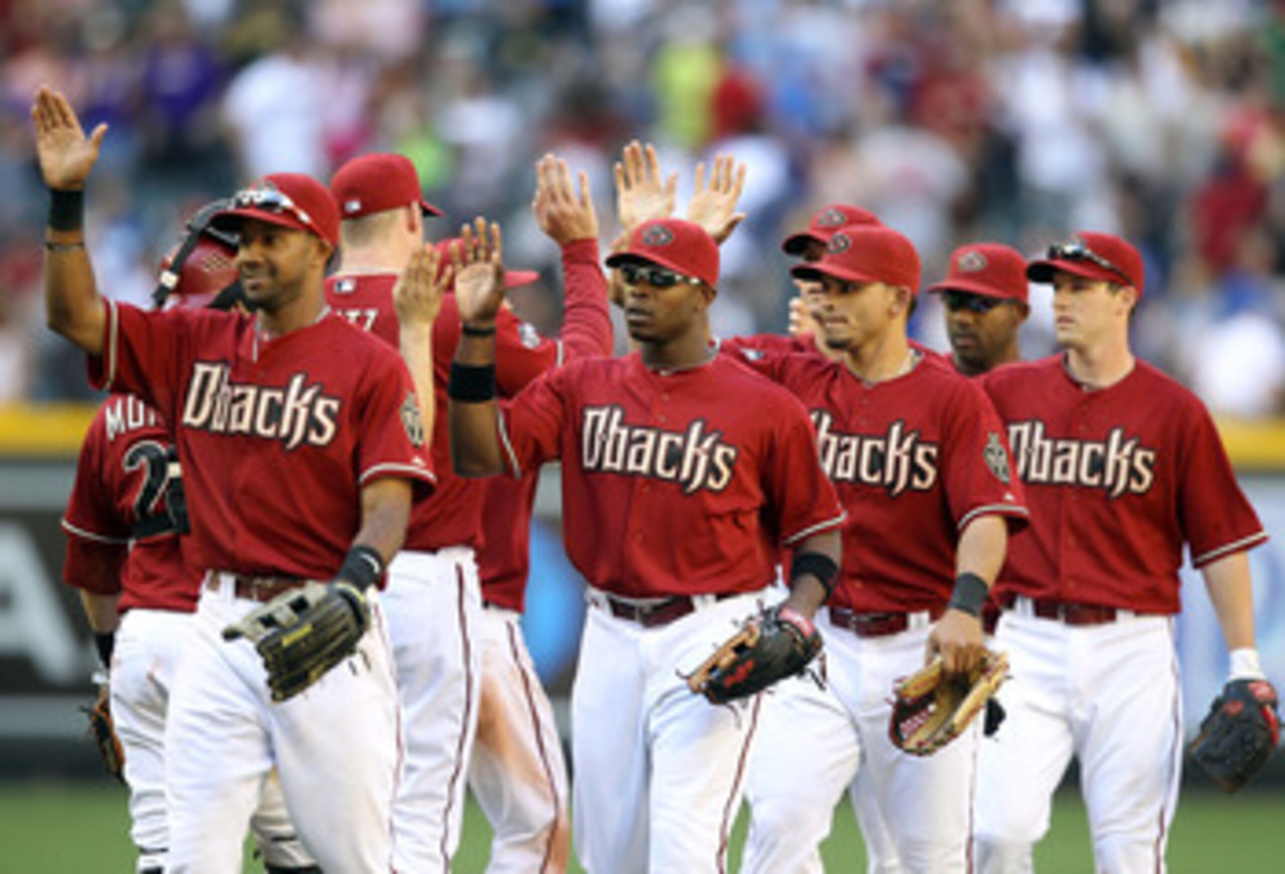 PHOENIX, AZ - MAY 01:  Justin Upton #10 of the Arizona Diamondbacks high fives teammates after defeating the Chicago Cubs in the Major League Baseball game at Chase Field on May 1, 2011 in Phoenix, Arizona.  The Diamondbacks defeated the Cubs 4-3. (Photo