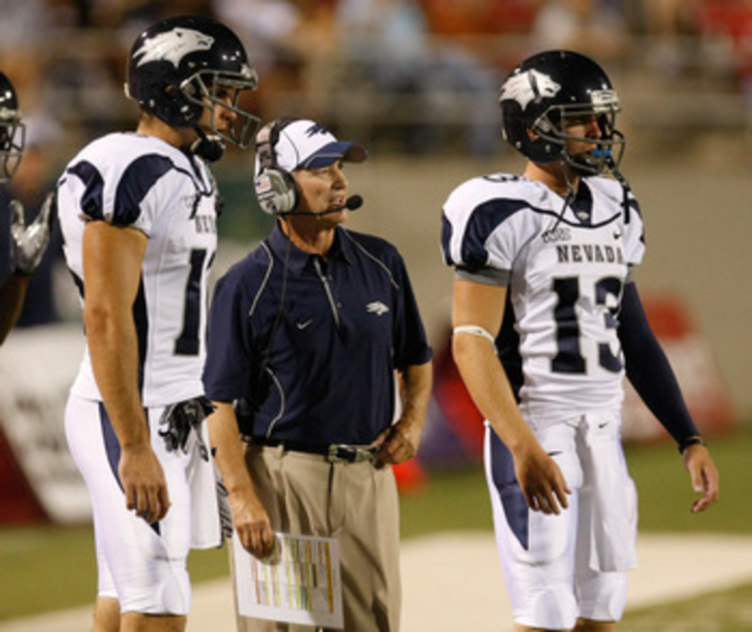 LAS VEGAS - OCTOBER 02: Nevada Reno Wolf Pack head coach Chris Ault (C) is flanked by quarterbacks Tyler Lantrip #16 and Mason Magleby #13 as Ault watches his players take on the UNLV Rebels at Sam Boyd Stadium October 2, 2010 in Las Vegas, Nevada. Nevad LAS VEGAS - OCTOBER 02: Nevada Reno Wolf Pack head coach Chris Ault (C) is flanked by quarterbacks Tyler Lantrip #16 and Mason Magleby #13 as Ault watches his players take on the UNLV Rebels at Sam Boyd Stadium October 2, 2010 in Las Vegas, Nevada. Nevad