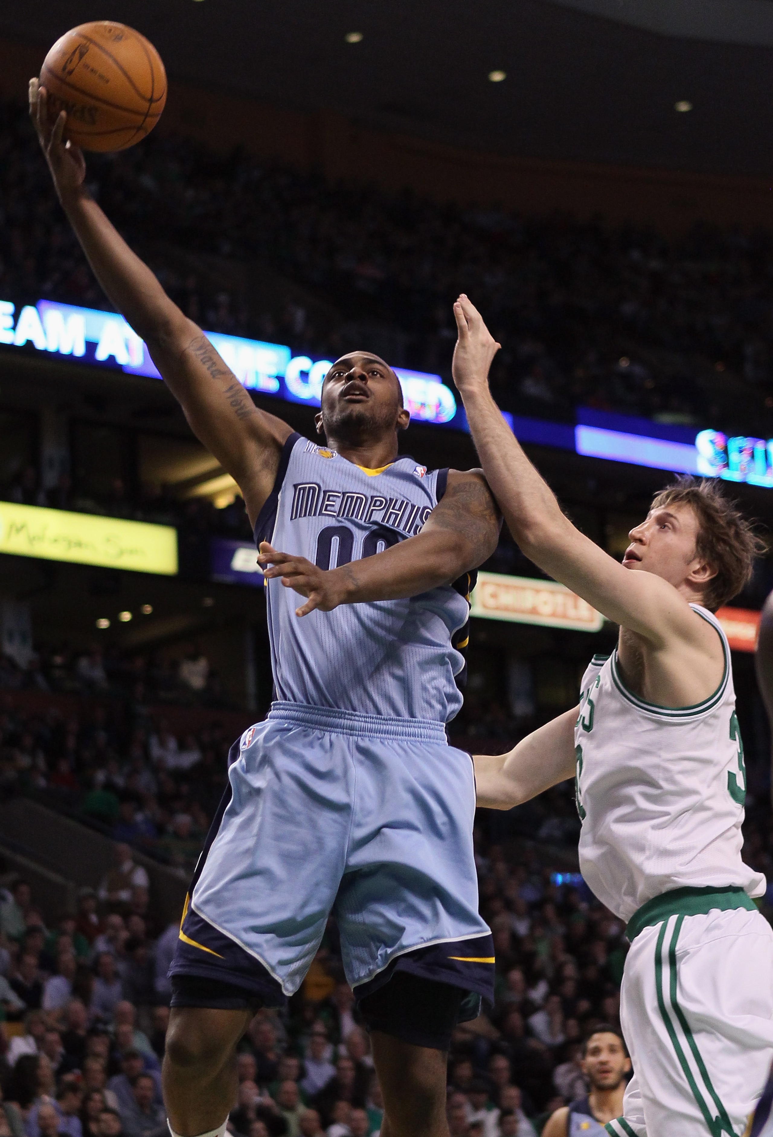 BOSTON, MA - MARCH 23:  Darrell Arthur #00 of the Memphis Grizzlies takes a shot as Troy Murphy #30 of the Boston Celtics defends on March 23, 2011 at the TD Garden in Boston, Massachusetts.  NOTE TO USER: User expressly acknowledges and agrees that, by d
