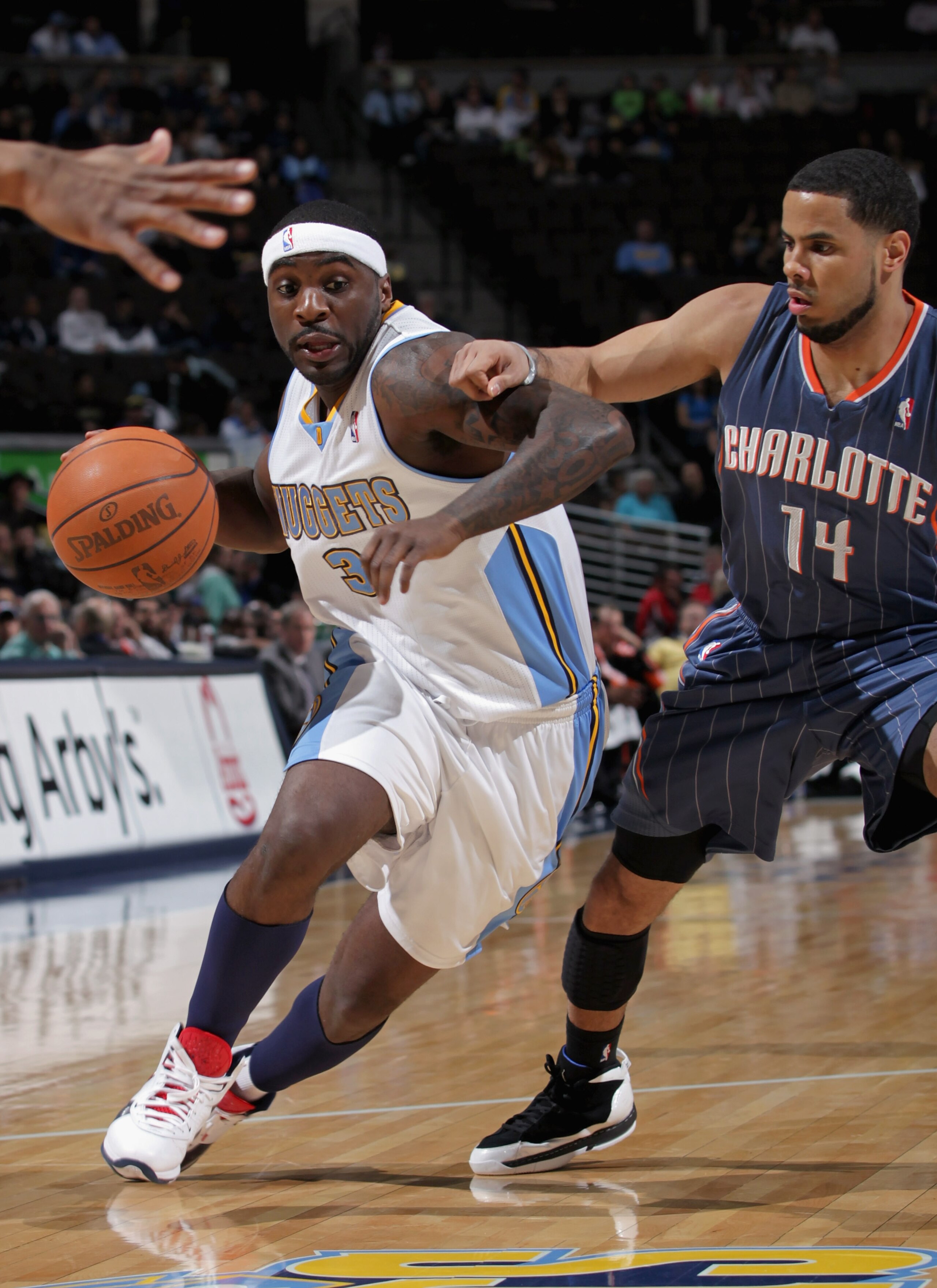 DENVER, CO - MARCH 02:  Ty Lawson #3 of the Denver Nuggets drives to the basket against D.J. Augustin #14 of the Charlotte Bobcats at the Pepsi Center on March 2, 2011 in Denver, Colorado. The Nuggets defeated the Bobcats 120-80. NOTE TO USER: User expres