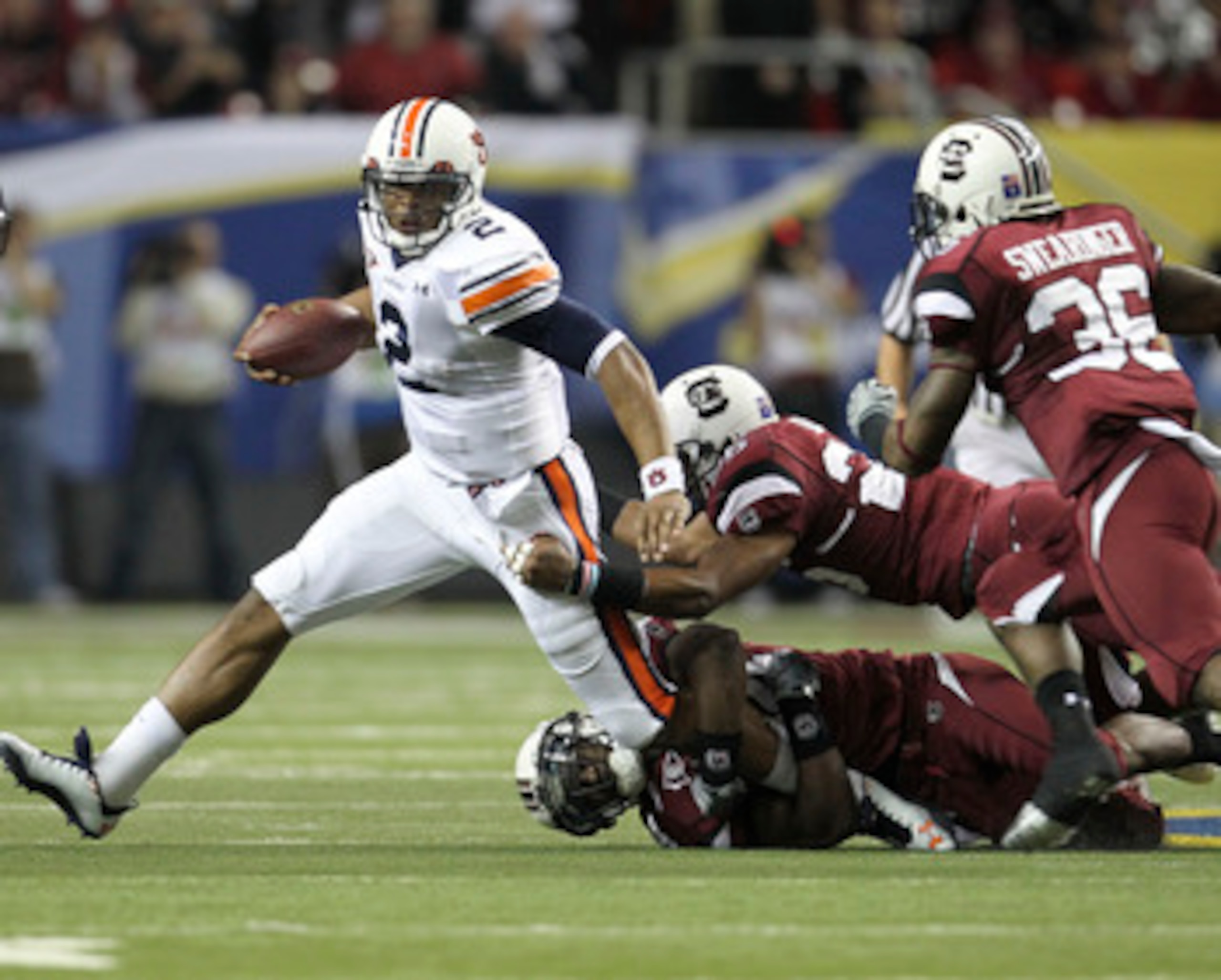 ATLANTA - DECEMBER 4:  Quarterback Cam Newton #2 of the Auburn Tigers is pursued by members of the South Carolina Gamecocks defense during the 2010 SEC Championship against the Auburn Tigers South Carolina Gamecocks at Georgia Dome on December 4, 2010 in 