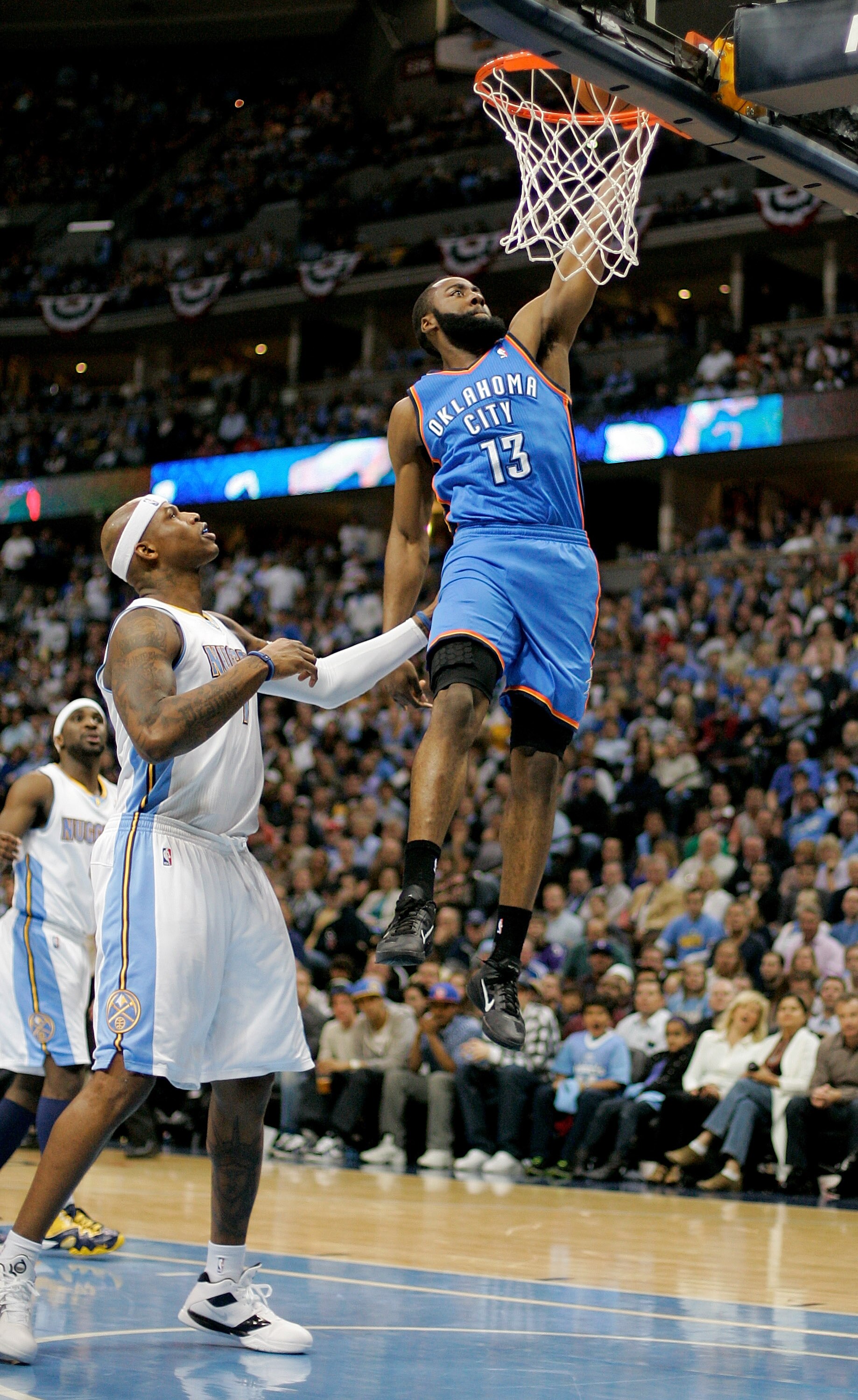 DENVER, CO - APRIL 25:  James Harden #13 of the Oklahoma City Thunder dunks over Al Harrington #7 of the Denver Nuggets in Game Four of the Western Conference Quarterfinals in the 2011 NBA Playoffs at Pepsi Center on April 25, 2011 in Denver, Colorado. NO