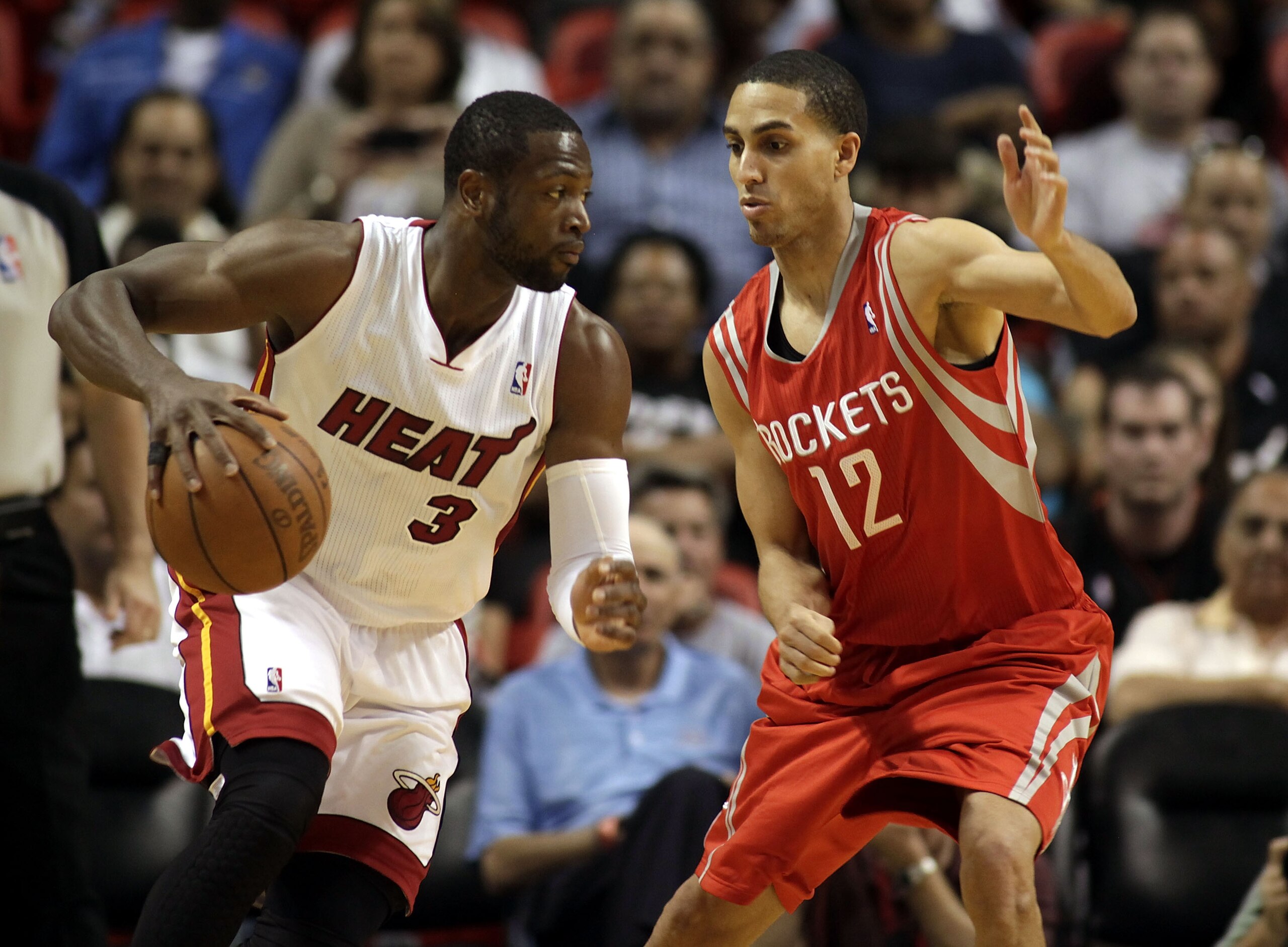 MIAMI, FL - MARCH 27: Guard Dwyane Wade of the Miami Heat drives against gurad Kevin Martin #12 of the Houston Rockets  at American Airlines Arena on March 27, 2011 in Miami, Florida. NOTE TO USER: User expressly acknowledges and agrees that, by downloadi