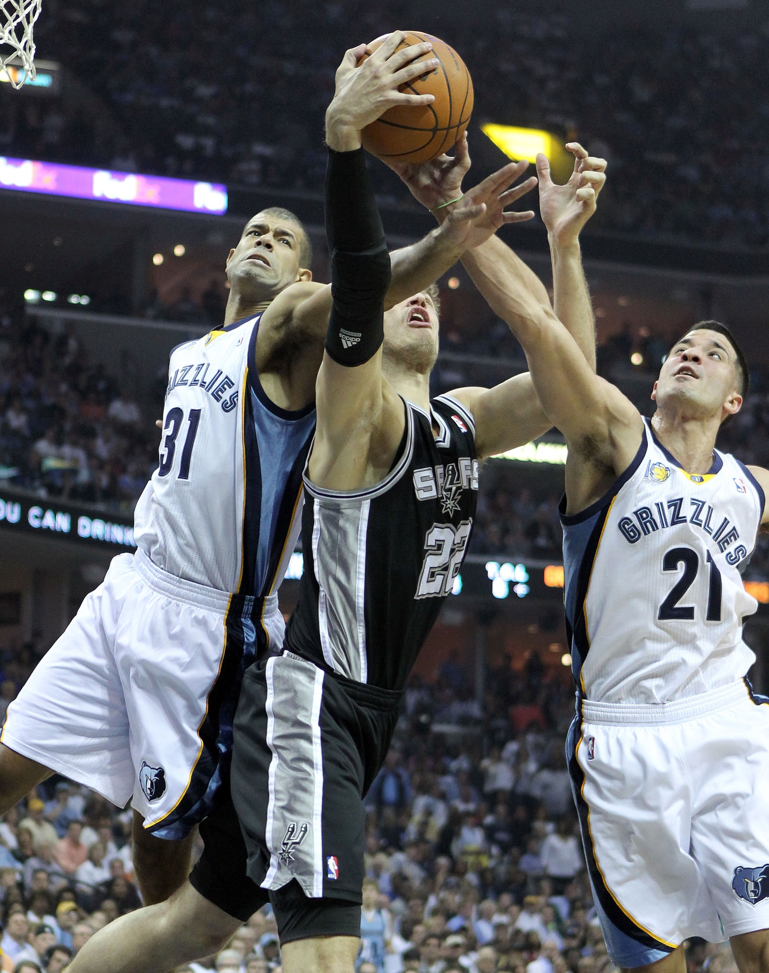 MEMPHIS, TN - APRIL 29:  Shane Battier #31 and Greivis Vasquez #21 of the Memphis Grizzlies and Tiago Splitter #22 of the San Antonio Spurs reach for a rebound in Game Six of the Western Conference Quarterfinals in the 2011 NBA Playoffs at FedExForum on A