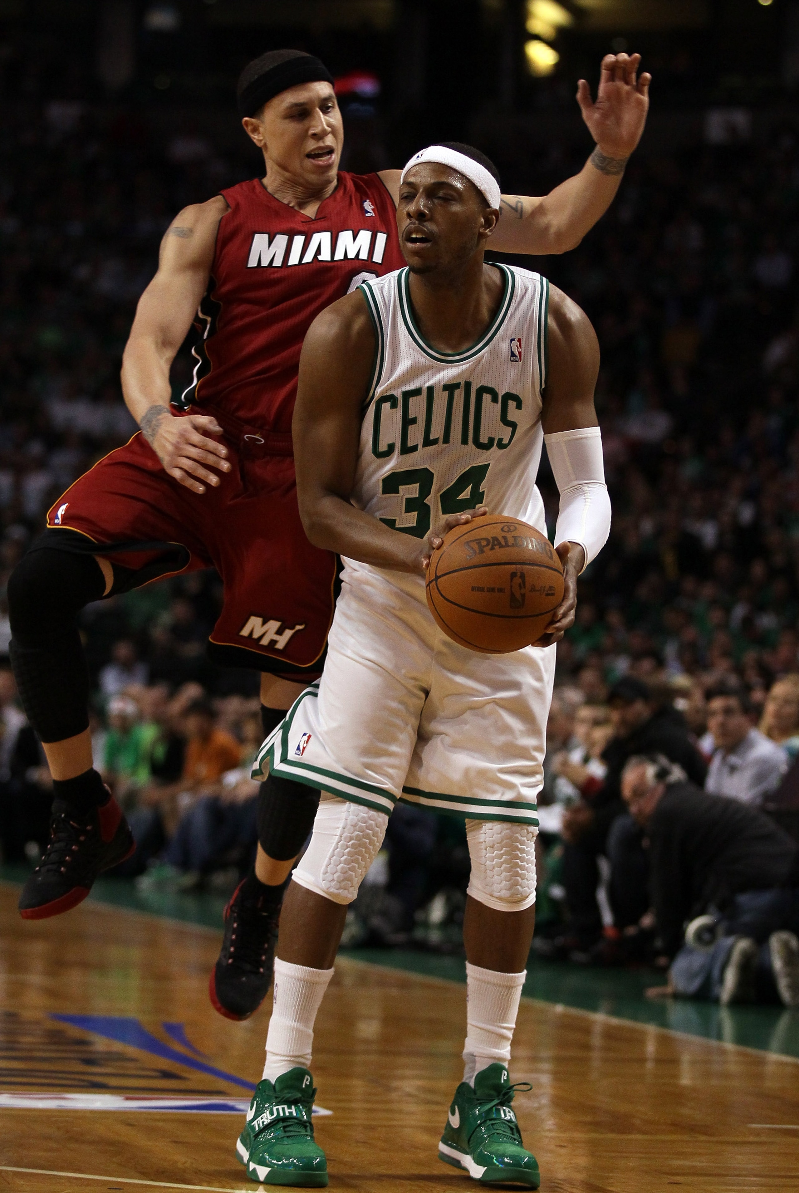 BOSTON, MA - MAY 07:  Mike Bibby #0 of the Miami Heat is called for a foul as he hits Paul Pierce #34 of the Boston Celtics in Game Three of the Eastern Conference Semifinals in the 2011 NBA Playoffs on May 7, 2011 at the TD Garden in Boston, Massachusett