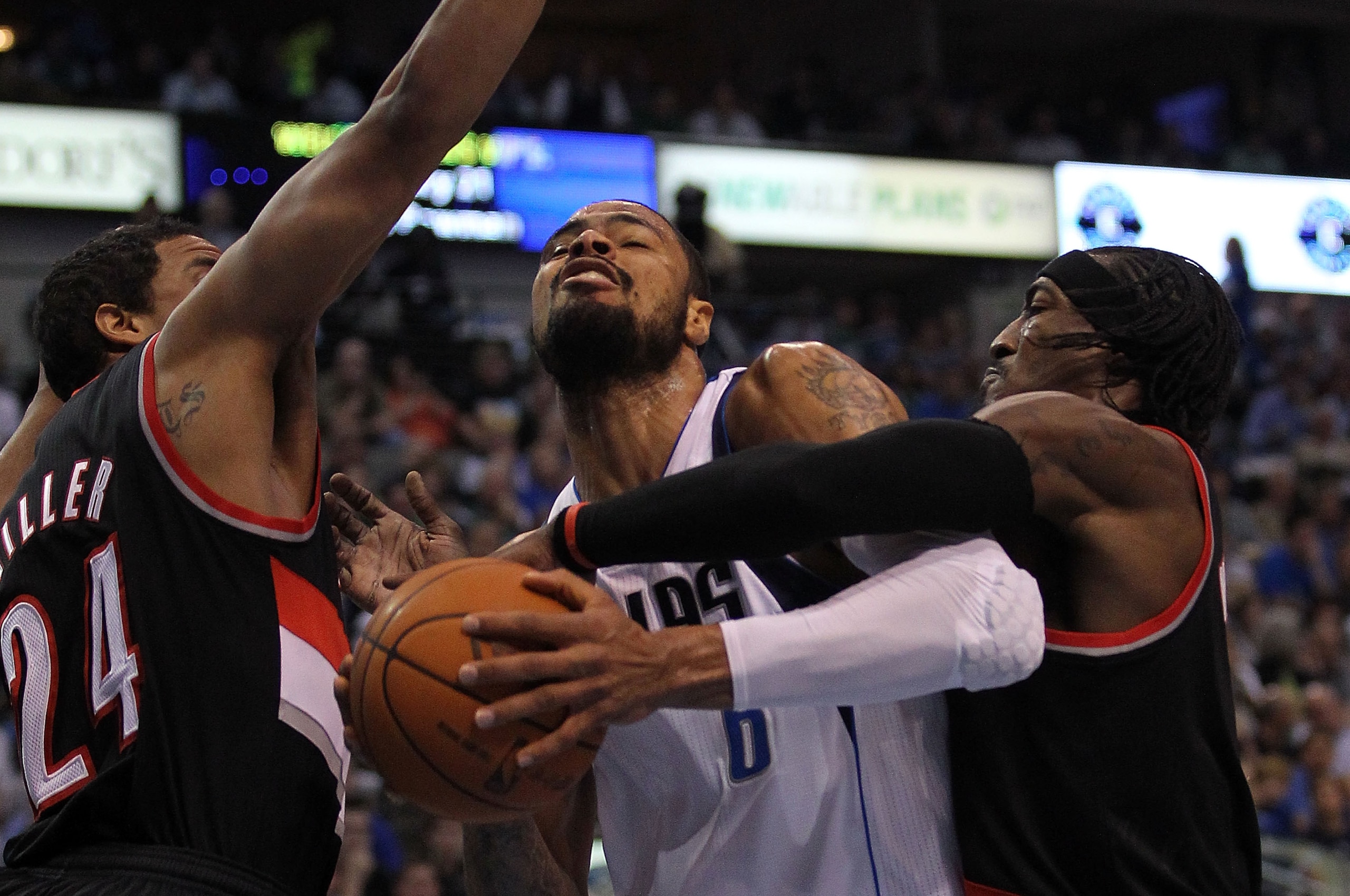 DALLAS, TX - APRIL 25:  Center Tyson Chandler #6 of the Dallas Mavericks is fouled by Gerald Wallace #3 of the Portland Trail Blazers in front of Andre Miller #24 in Game Five of the Western Conference Quarterfinals during the 2011 NBA Playoffs on April 2