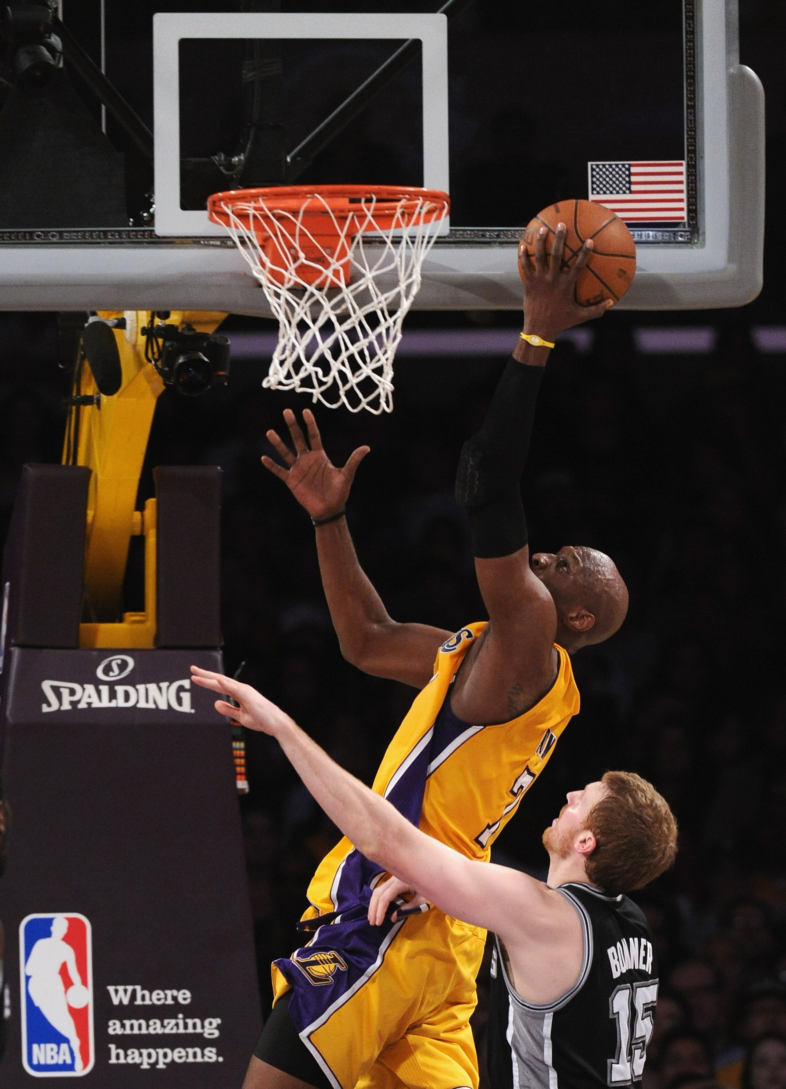 LOS ANGELES, CA - APRIL 12:  Lamar Odom #7 of the Los Angeles Lakers scores on a layup as he is fouled by Matt Bonner #15 of the San Antonio Spurs during the game at Staples Center on April 12, 2011 in Los Angeles, California.  NOTE TO USER: User expressl