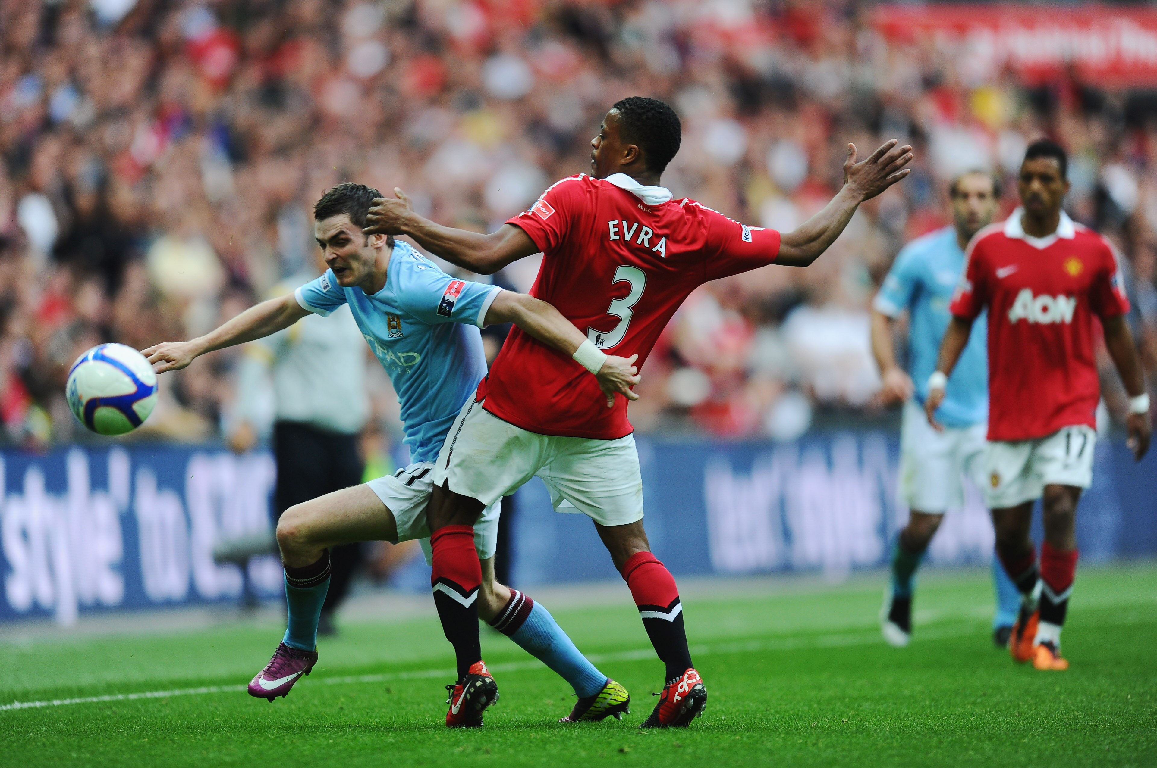 LONDON, ENGLAND - APRIL 16:   Adam Johnson of Manchester City goes past  Patrice Evra of Manchester United during the FA Cup sponsored by E.ON semi final match between Manchester City and Manchester United at Wembley Stadium on April 16, 2011 in London, E