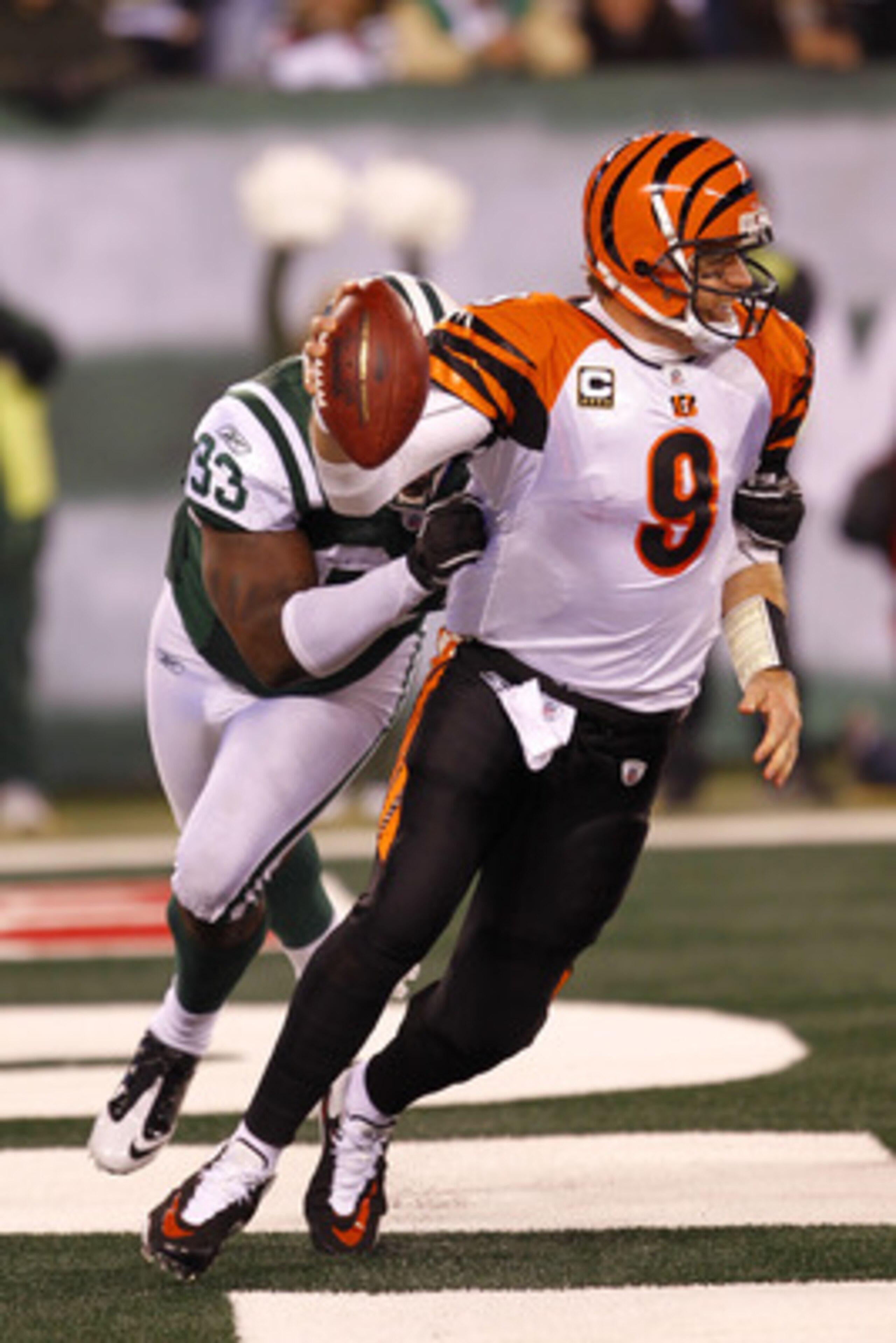 EAST RUTHERFORD, NJ - NOVEMBER 25:  Quarterback Carson Palmer #9 of the Cincinnati Bengals is tackled for a safety by Trevor Pryce #93 of the New York Jets at New Meadowlands Stadium on November 25, 2010 in East Rutherford, New Jersey. The Jets defeated t