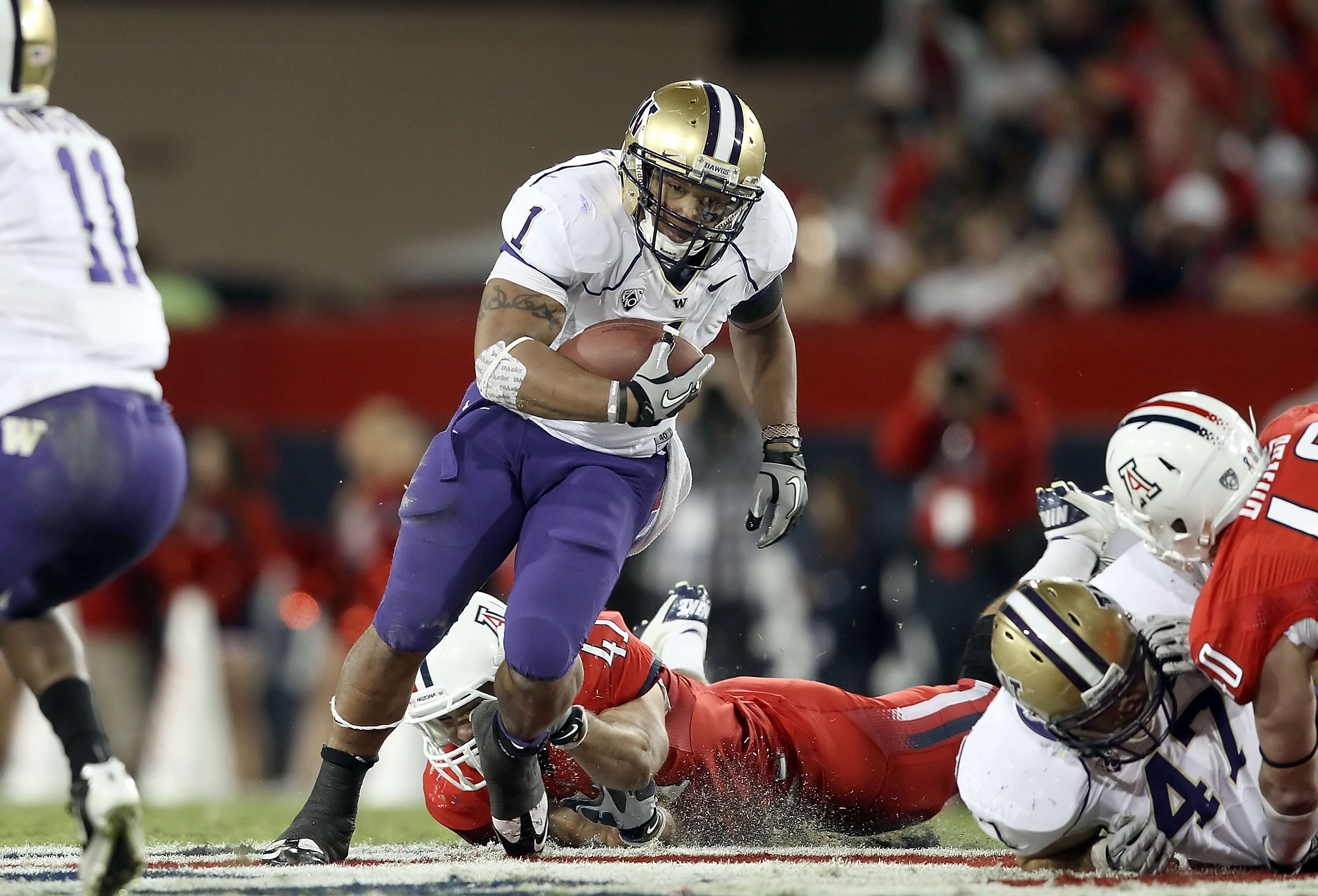 TUCSON, AZ - OCTOBER 23:  Runningback Chris Polk #1 of the Washington Huskies rushes the football during the college football game against the Arizona Wildcats at Arizona Stadium on October 23, 2010 in Tucson, Arizona. The Wildcats defeated the Huskies 44