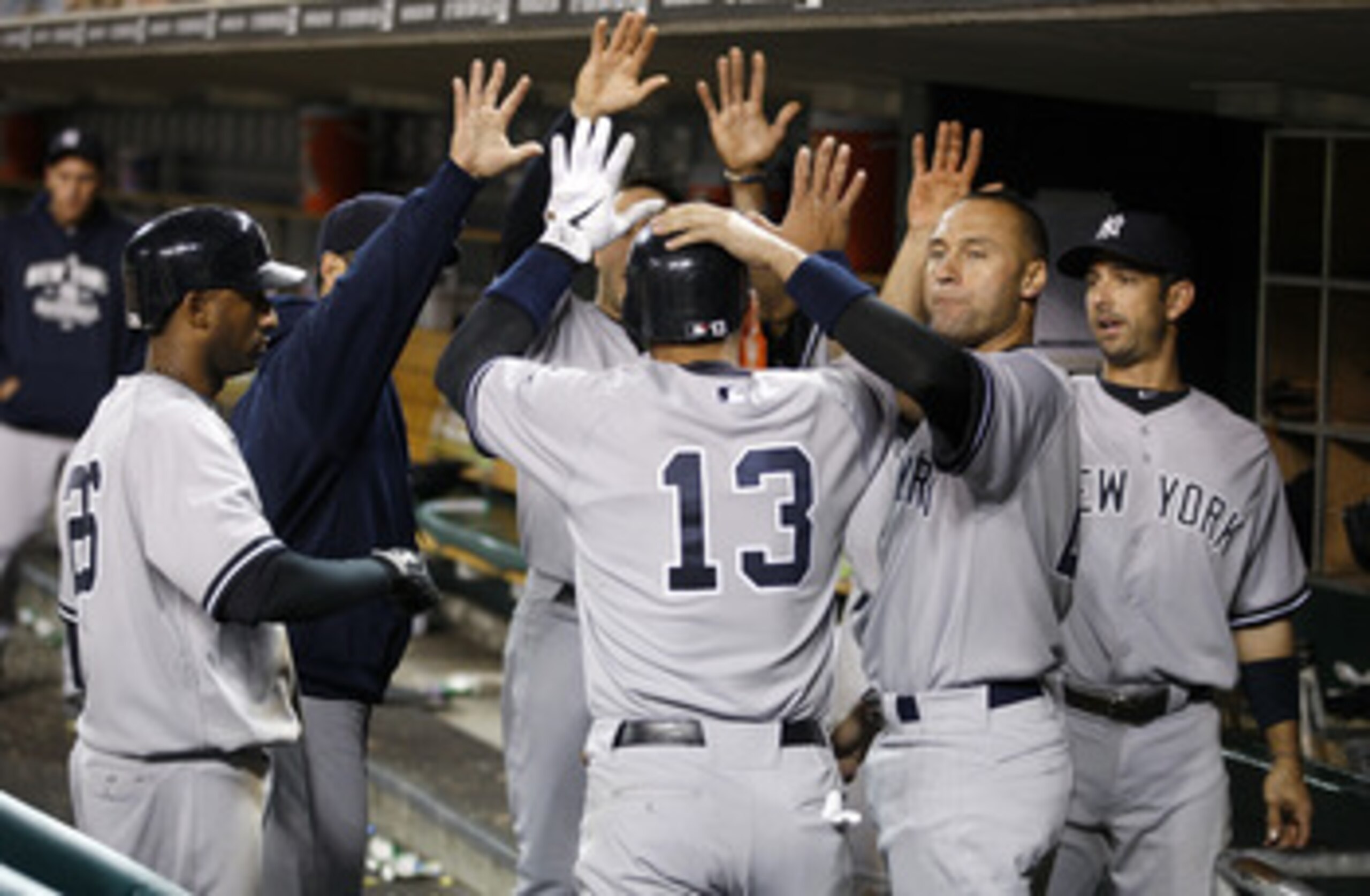 DETROIT, MI - MAY 02: Alex Rodriguez #13 of the New York Yankees celebrates with teammates in the dugout after scoring a ninth inning run while playing the Detroit Tigers at Comerica Park on May 2, 2011 in Detroit, Michigan. New York won the game 5-3.  (P