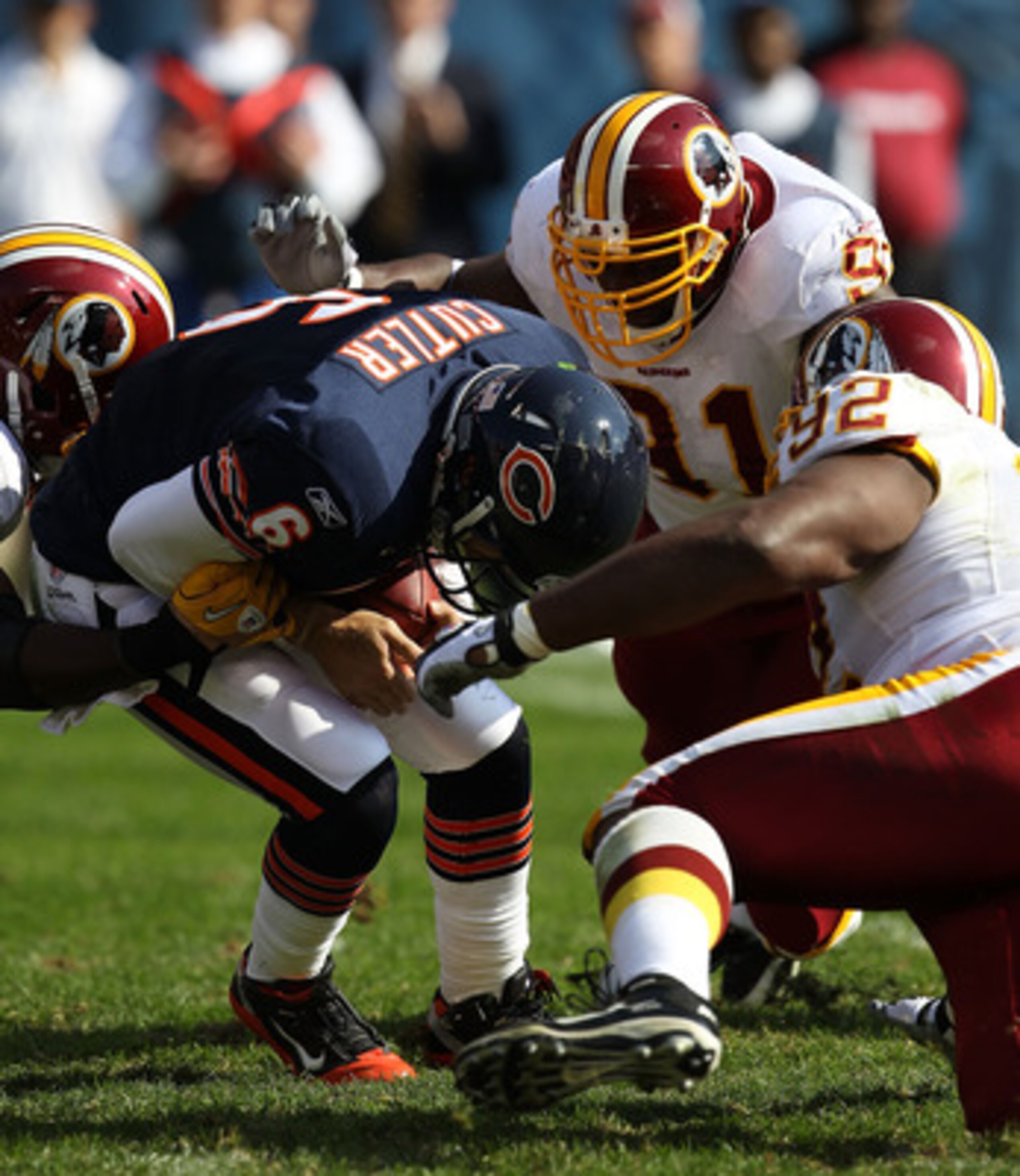 CHICAGO - OCTOBER 24: Jay Cutler #6 of the Chicago Bears is sacked by members of the Washington Redskins defense including Vonnie Hoilday #91 and Albert Haynesworth #92 at Soldier Field on October 24, 2010 in Chicago, Illinois. The Redskins defeated the B