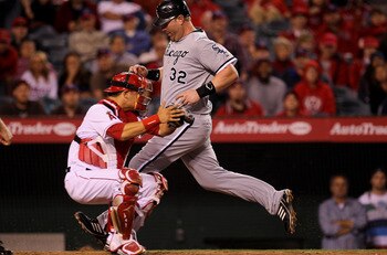 ANAHEIM, CA - MAY 11:  Adam Dunn #32 of the Chicago White Sox scores an insurance run in the tenth inning on a sacrifice fly ahead of the tag by catcher Hank Conger #16 of the Los Angeles Angels of Anaheim on May 11, 2011 at Angel Stadium in Anaheim, Cali
