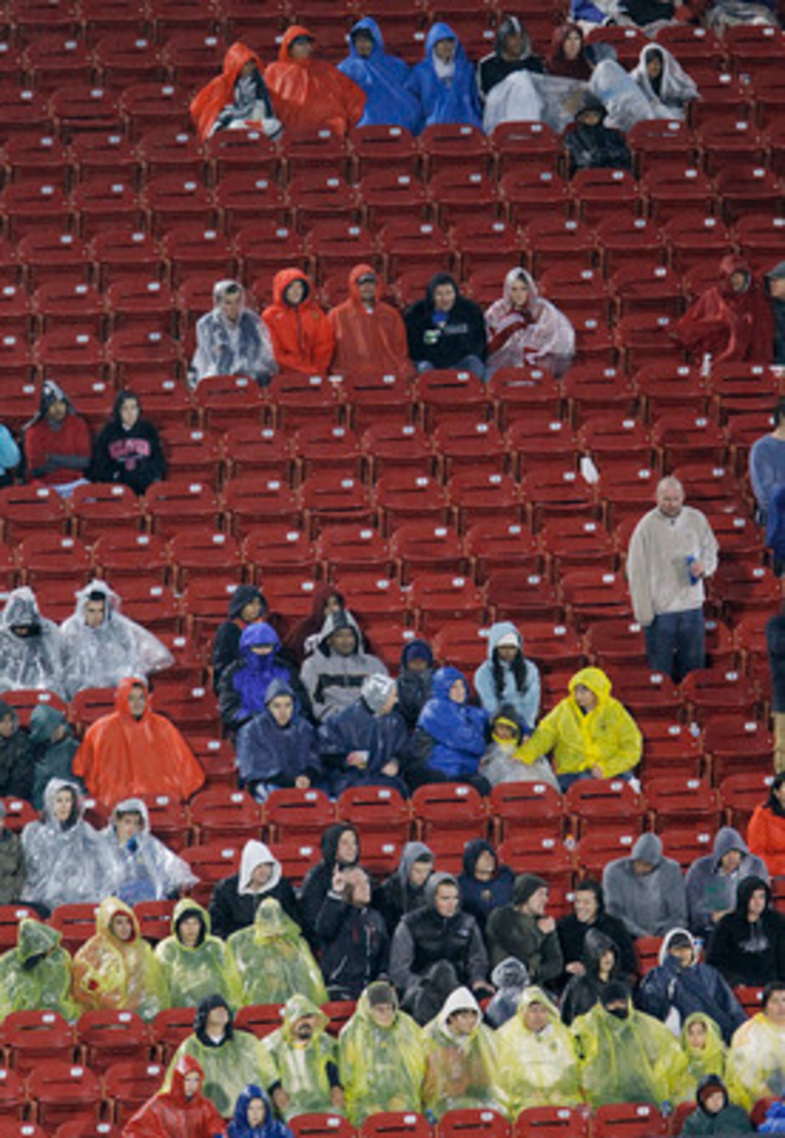 FRISCO, TX - MAY 1: Soccer fans brave a cold rain during a soccer match between FC Dallas and the Los Angeles Galaxy in the second half at Pizza Hut Park on May 1, 2011 in Frisco, Texas. The game was stopped midway through the second half due to severe we