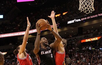 MIAMI, FL - MARCH 06:  LeBron James #6 of the Miami Heat shoots over Joakim Noah #13 and Omer Asik #3 of the Chicago Bulls during a game at American Airlines Arena on March 6, 2011 in Miami, Florida. NOTE TO USER: User expressly acknowledges and agrees th