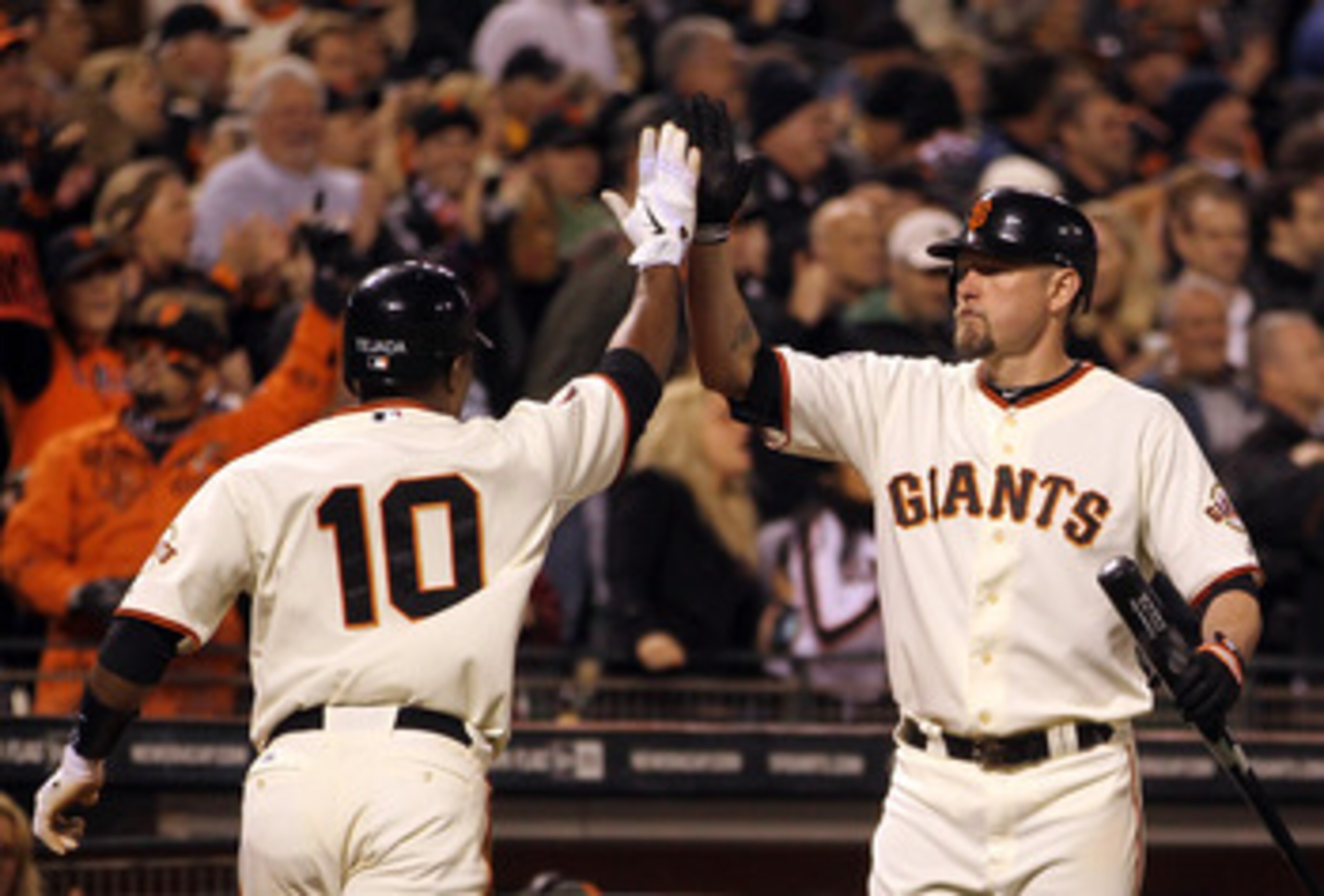 SAN FRANCISCO, CA - MAY 11:  Miguel Tejada #10 of the San Francisco Giants is congratulated by Aubrey Huff #17 of the San Francisco Giants after he scored the go ahead run in the sixth inning against the Arizona Diamondbacks at AT&T Park on May 11, 2011 i
